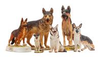 A Group of Six Porcelain and Ceramic German Shepherds Width of widest 9 1/2 inches.