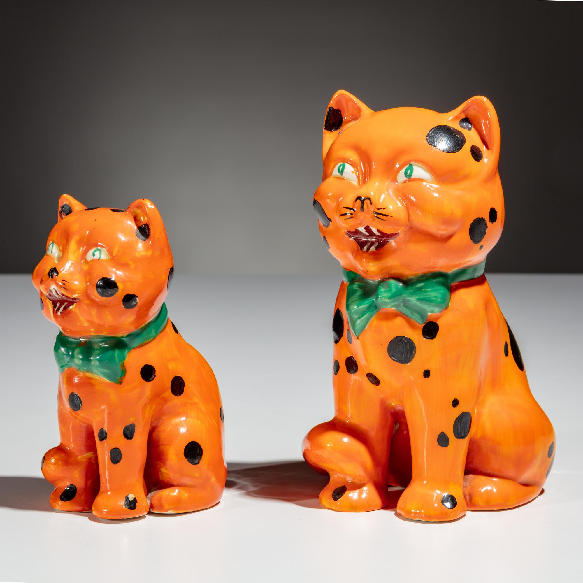 Clarice Cliff (English, 1899–1972) — Two Orange Laughing Cat Figures