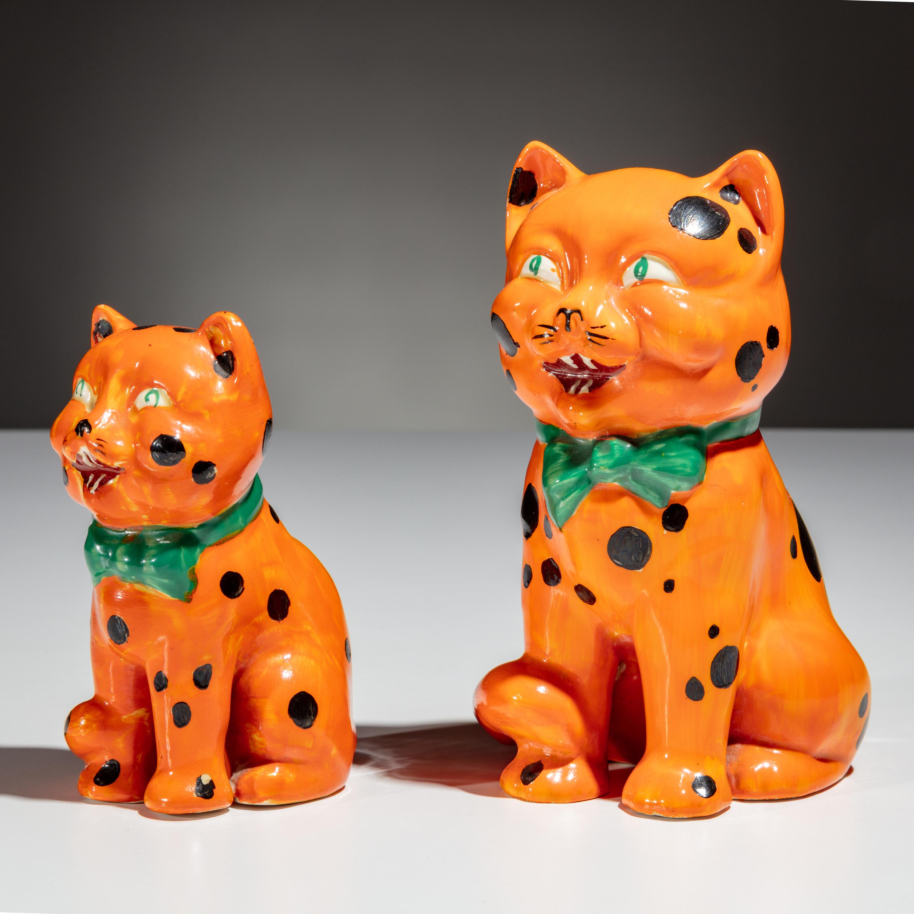 Clarice Cliff (English, 1899–1972) — Two Orange Laughing Cat Figures