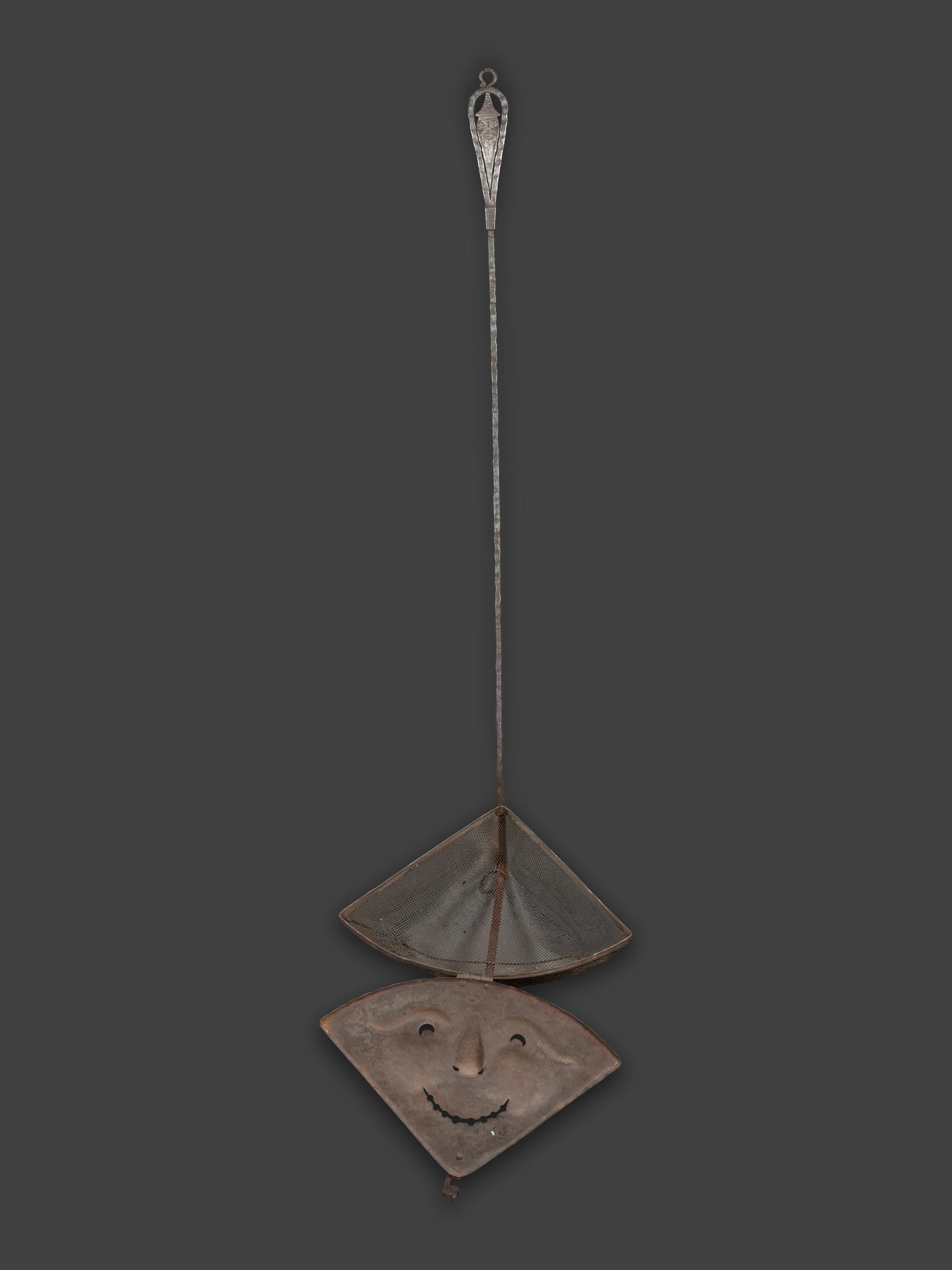 A Forged and Hammered Iron Figural Chestnut Roaster