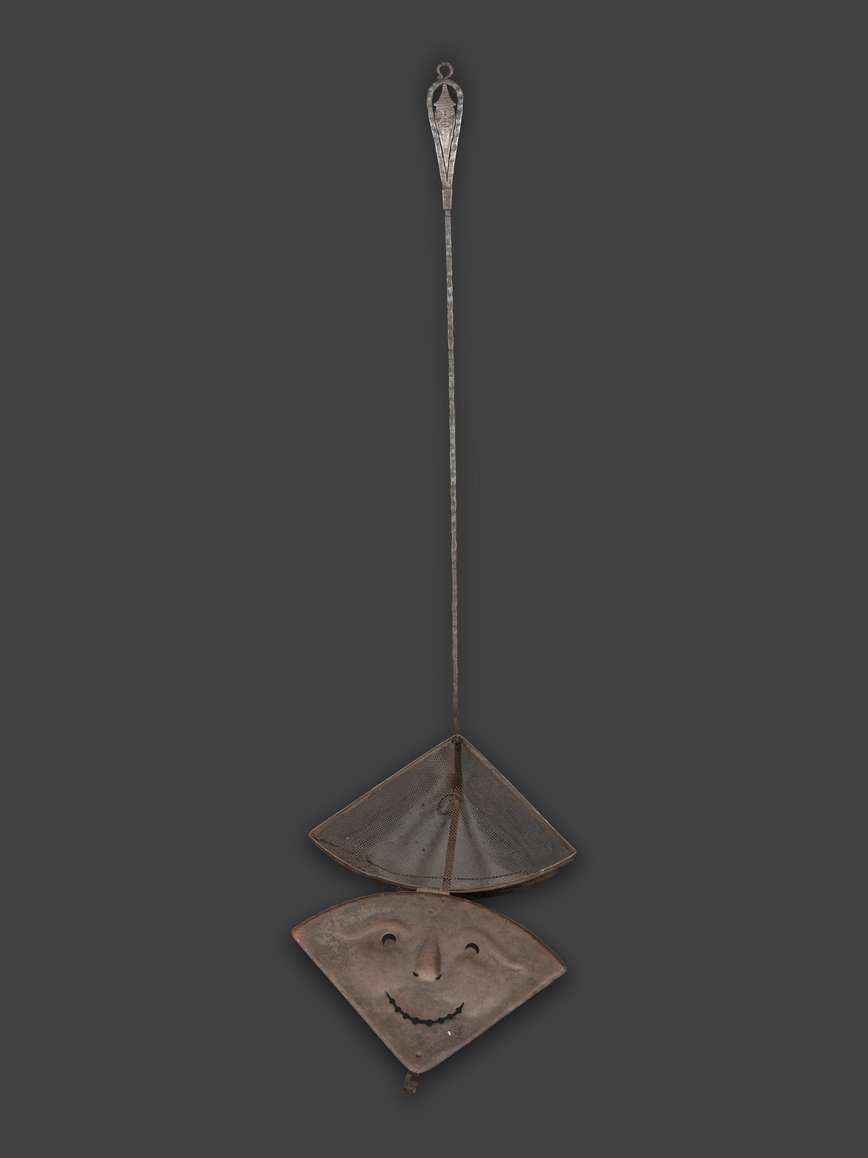 A Forged and Hammered Iron Figural Chestnut Roaster