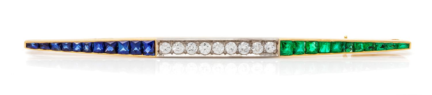 A Platinum Topped Yellow Gold, Diamond, Emerald and Sapphire Bar Brooch, 4.40 dwts.