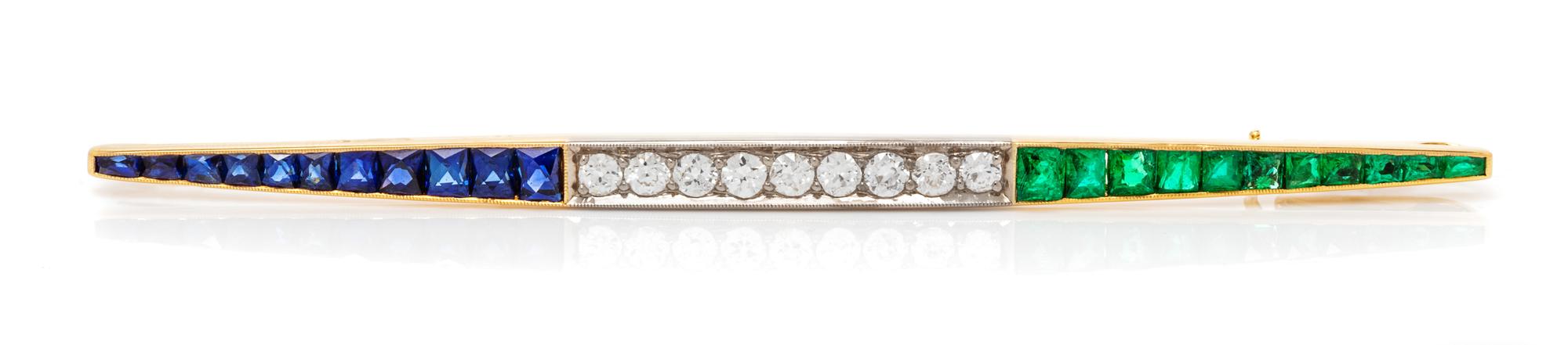 A Platinum Topped Yellow Gold, Diamond, Emerald and Sapphire Bar Brooch, 4.40 dwts.