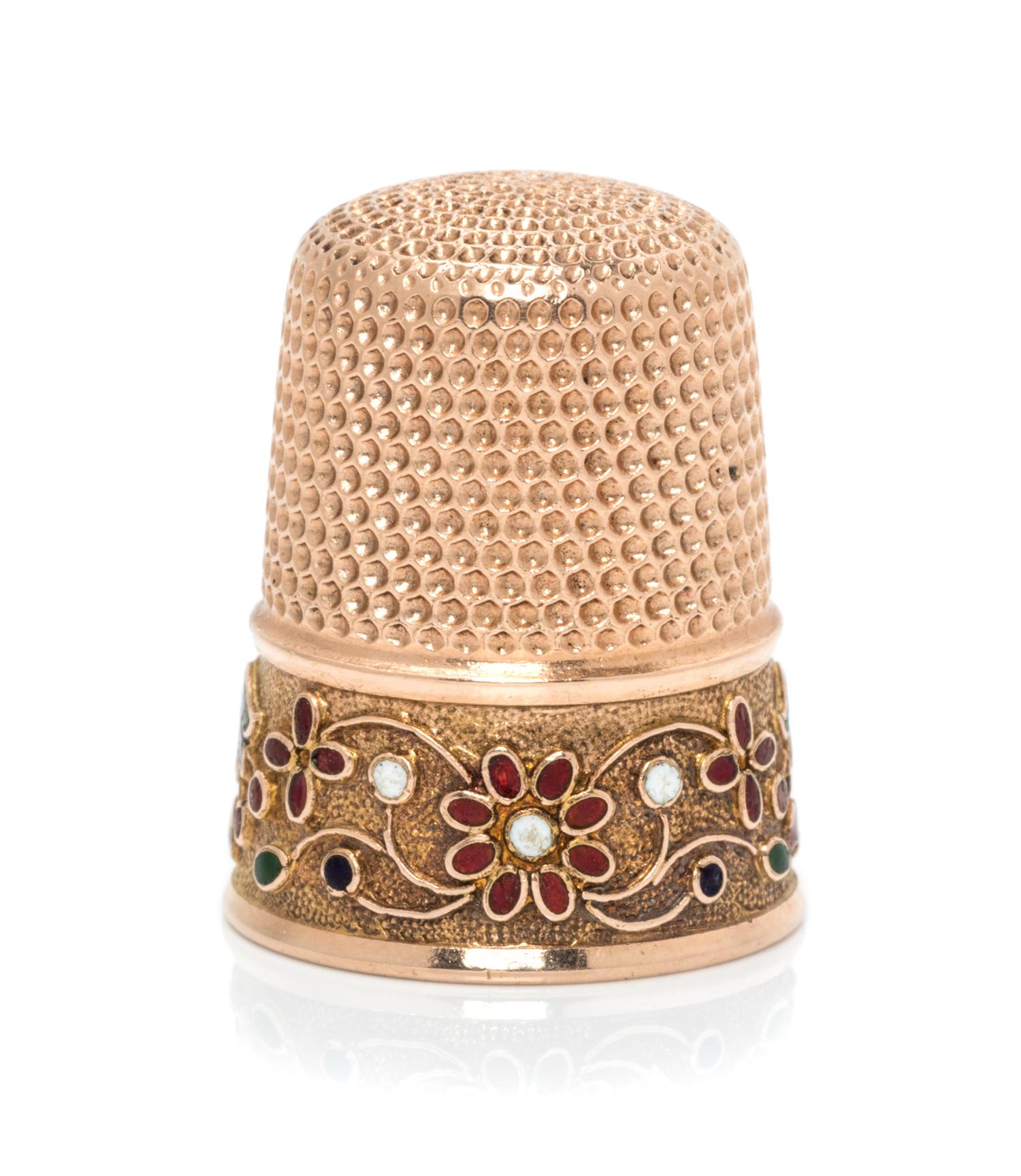 An American 14-Karat Gold and Enamel Thimble, Simons Bros., Philadelphia, PA, the knurled top and body above a polychrome enamel floral