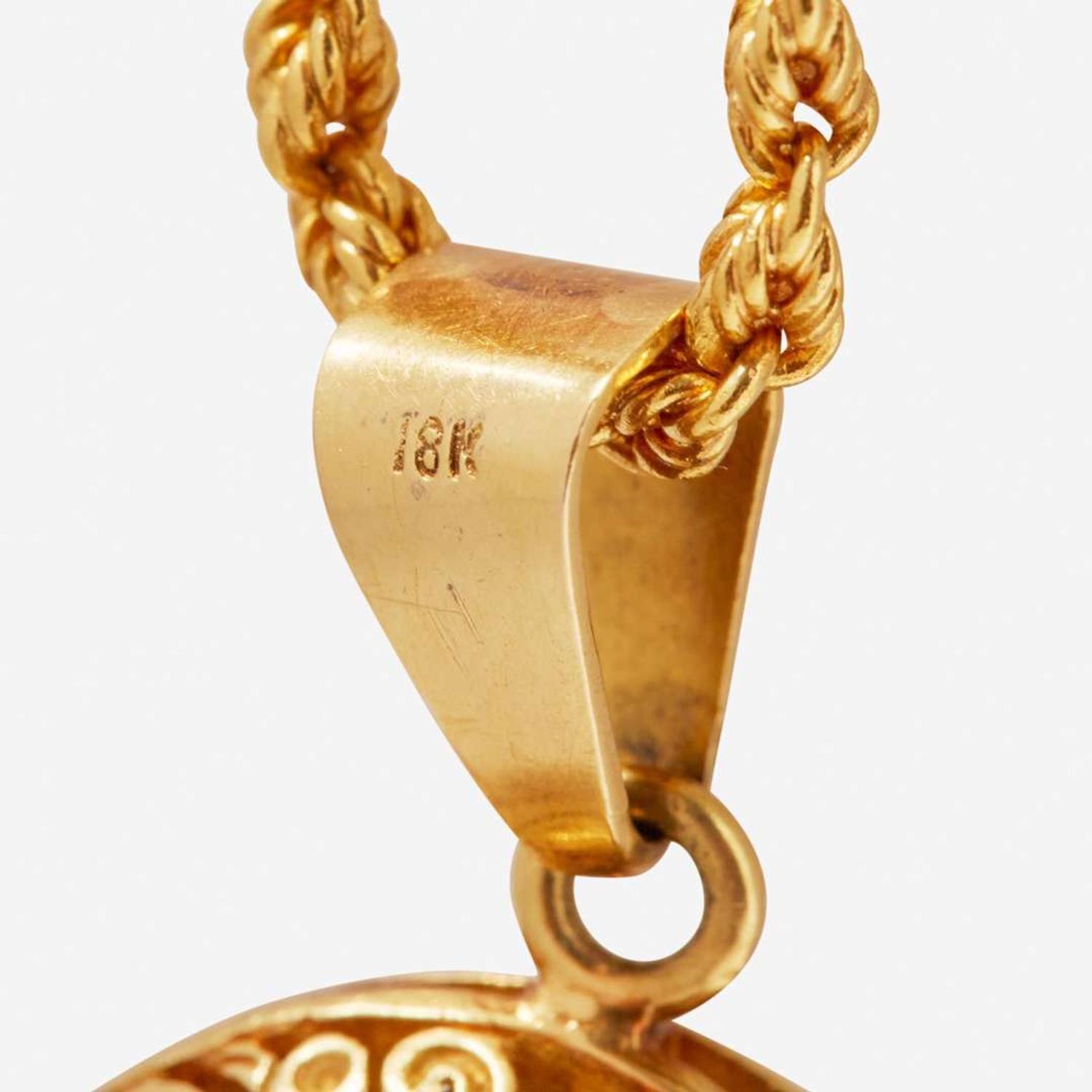 A Yellow Gold Peruvian Pendant and Chain
