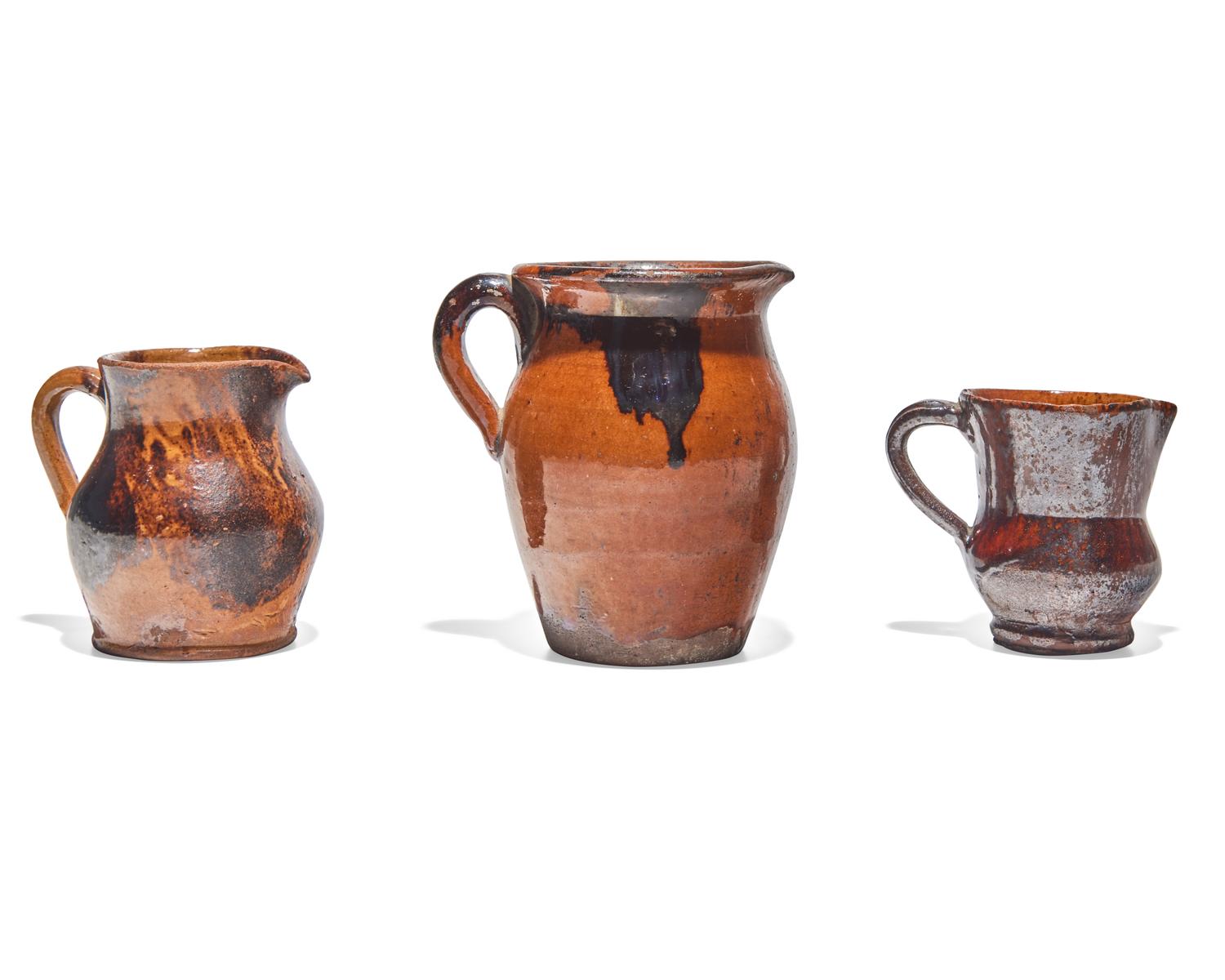 Three Glazed and Manganese Splashed Redware Creamers, 19th Century