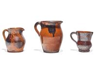 Three Glazed and Manganese Splashed Redware Creamers, 19th Century