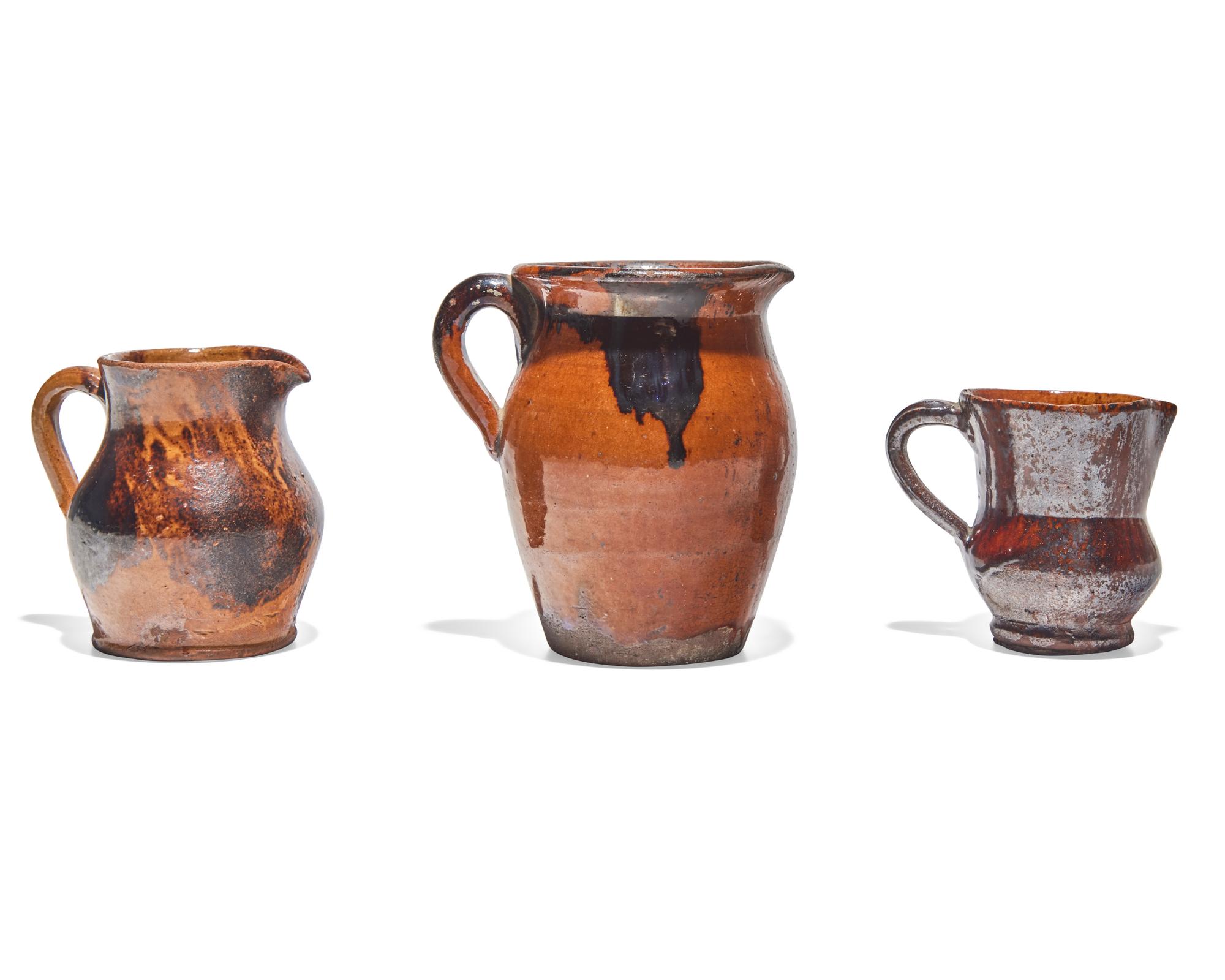 Three Glazed and Manganese Splashed Redware Creamers, 19th Century
