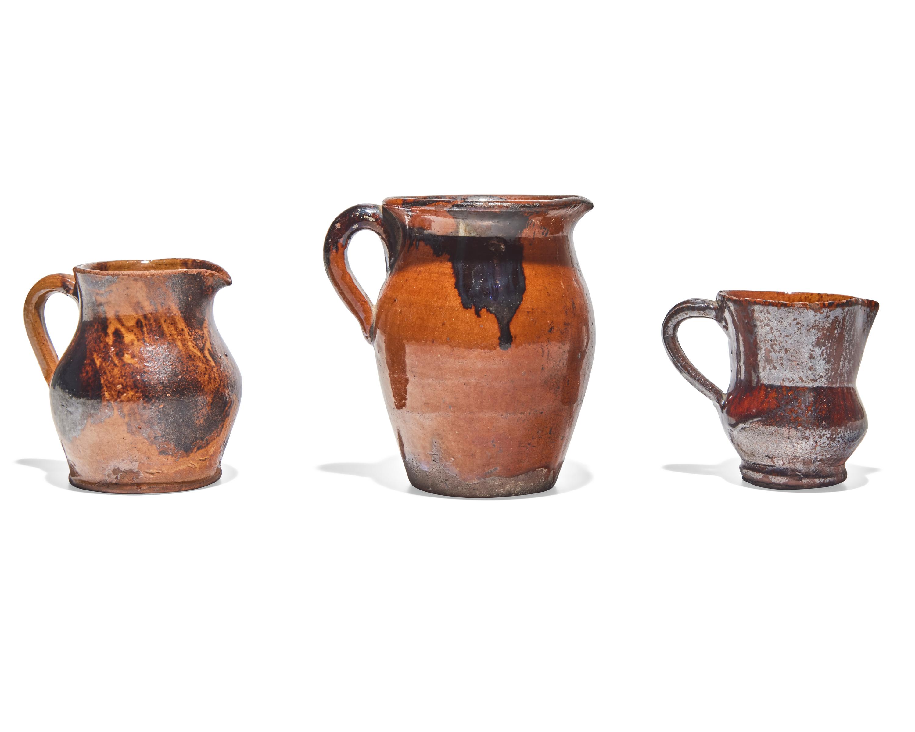 Three Glazed and Manganese Splashed Redware Creamers, 19th Century