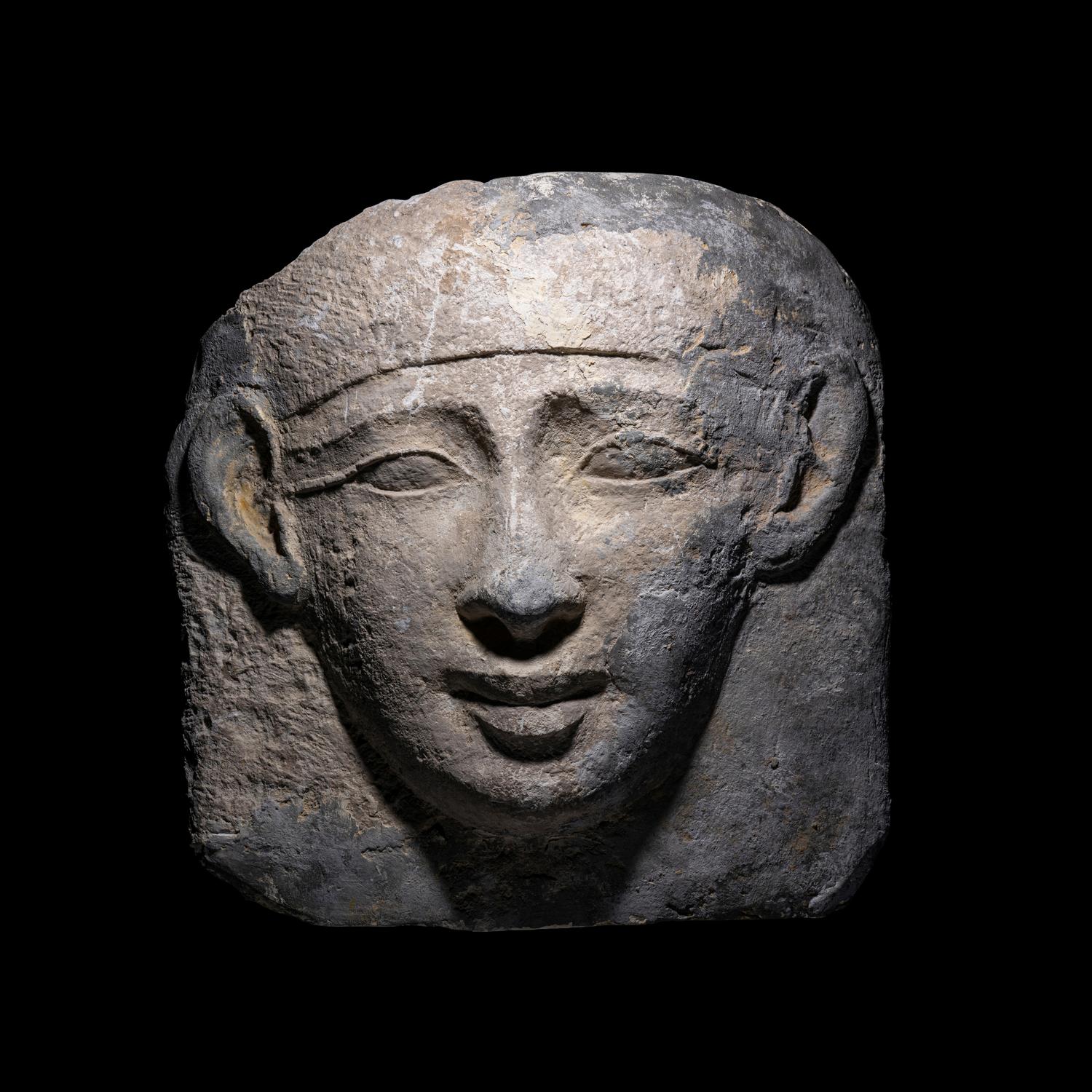 An Egyptian Limestone Mask from an Anthropoid Sarcophagus