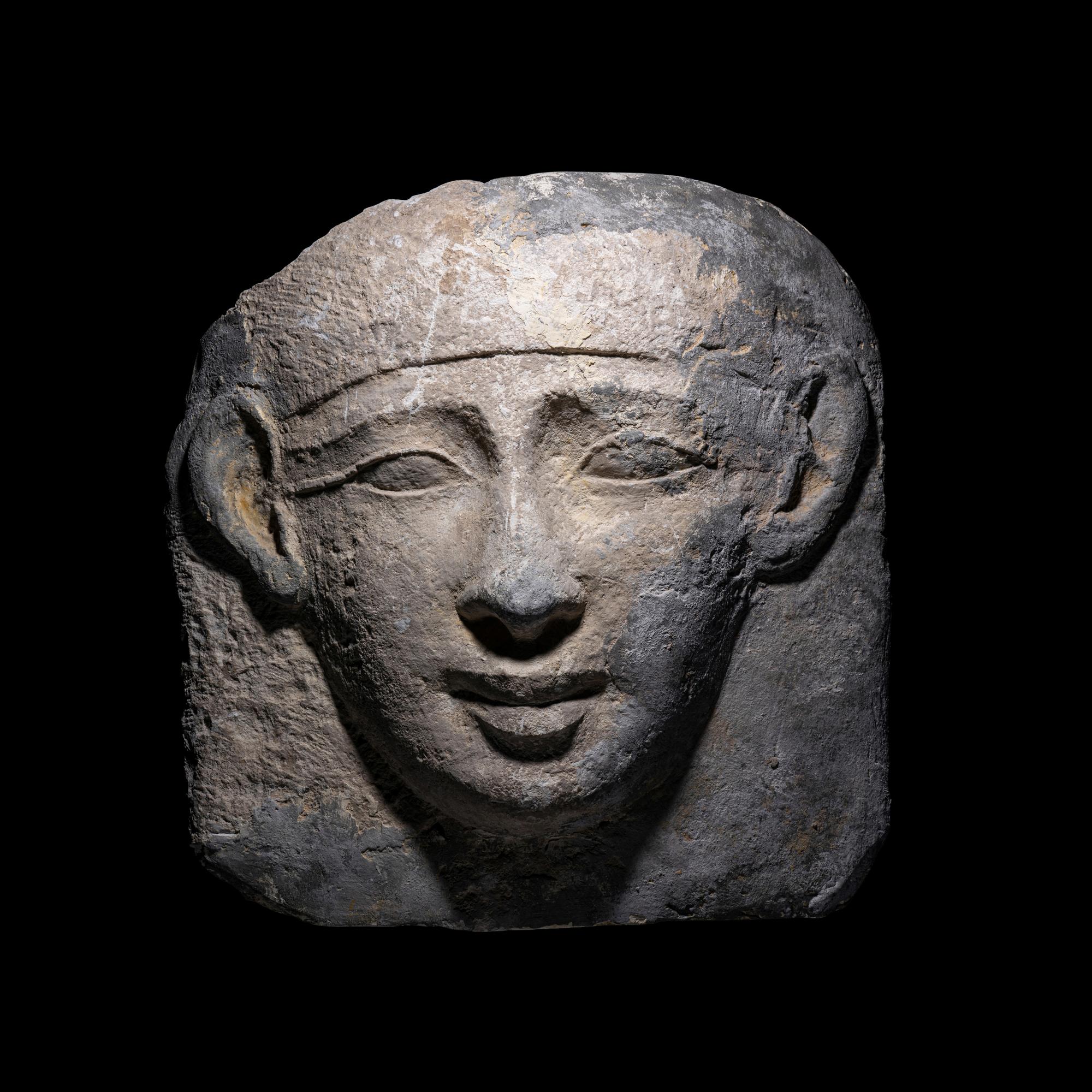An Egyptian Limestone Mask from an Anthropoid Sarcophagus