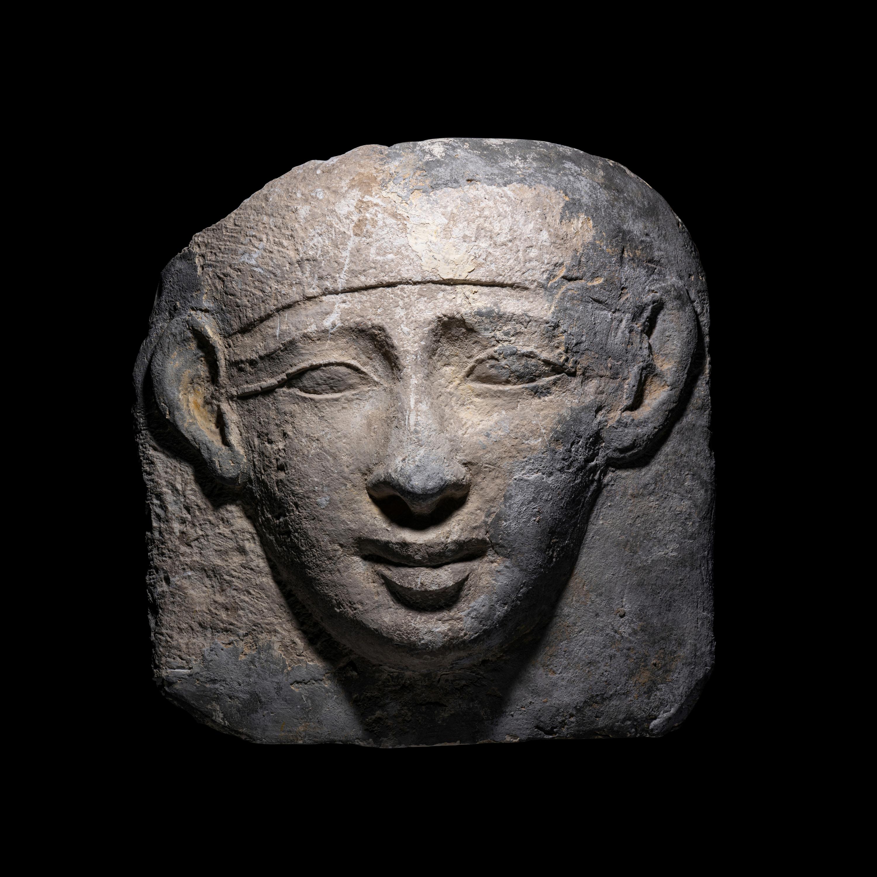 An Egyptian Limestone Mask from an Anthropoid Sarcophagus
