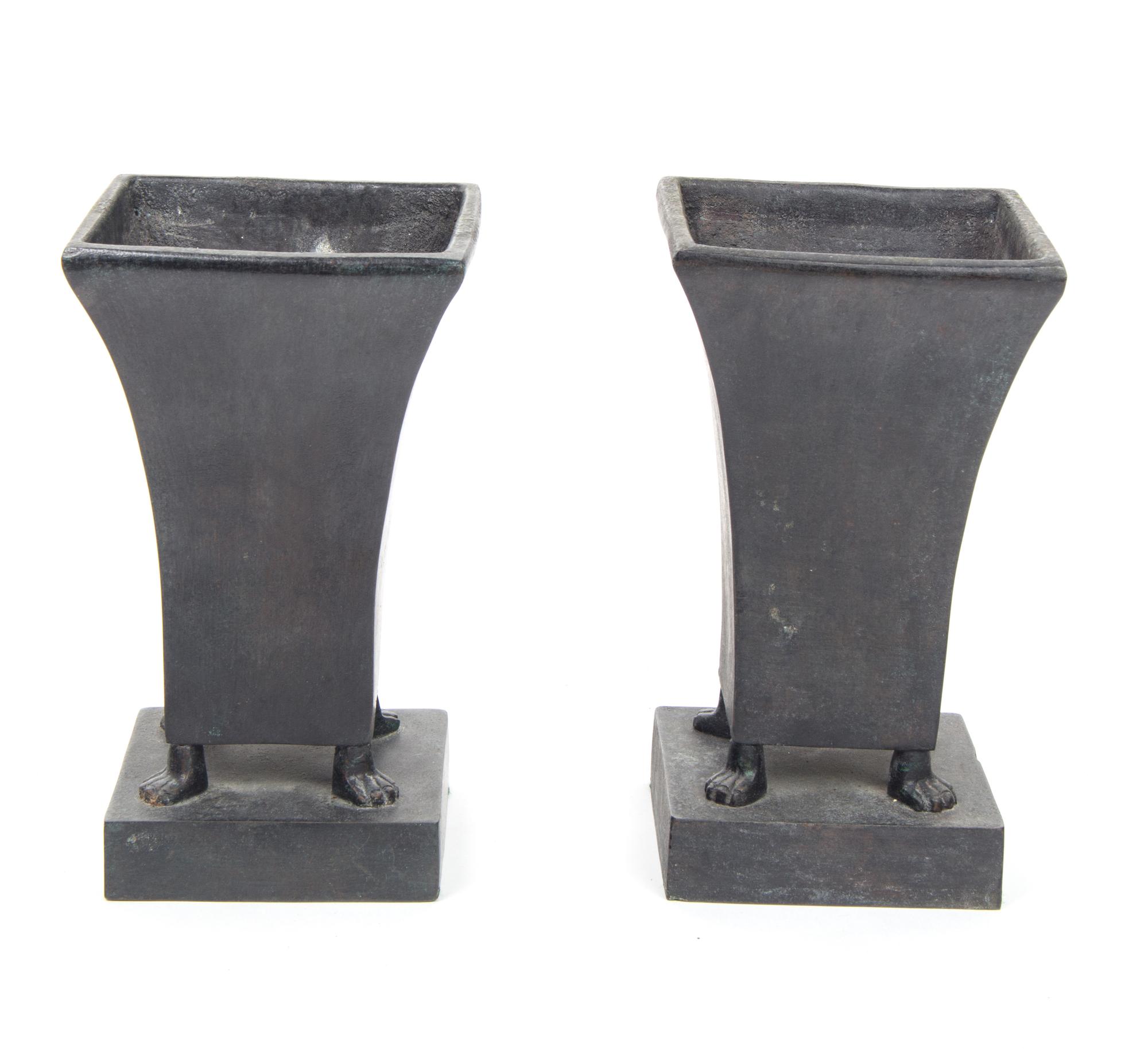A Pair of Bronze Footed Urns Height 9 1/2 inches each.