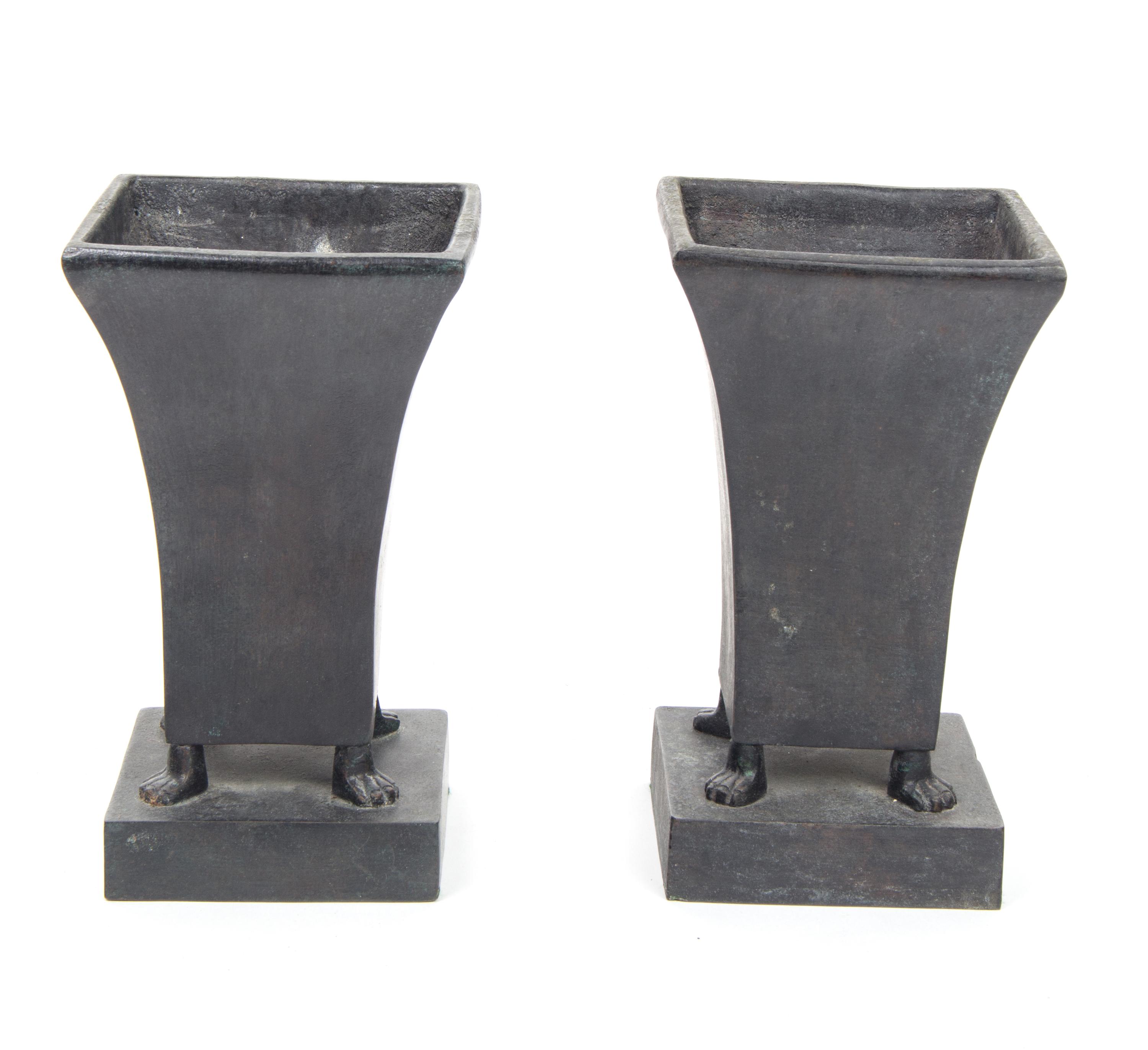 A Pair of Bronze Footed Urns Height 9 1/2 inches each.