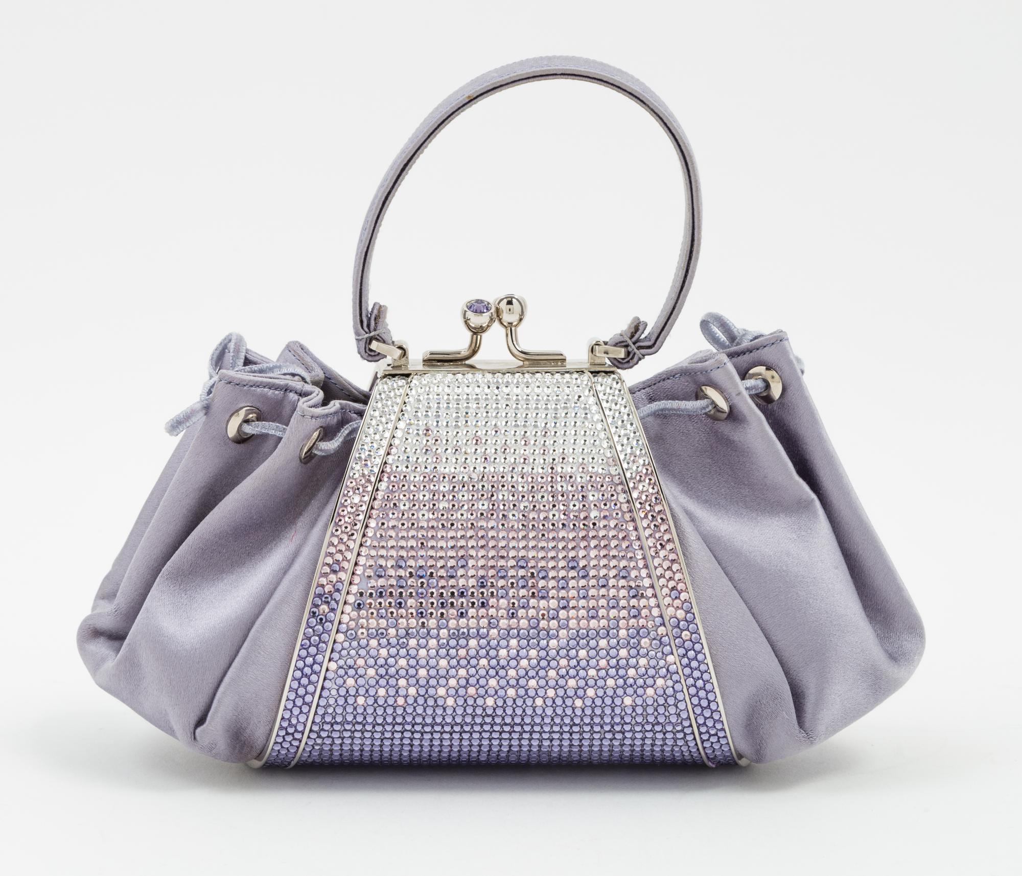 A Judith Leiber Purple Satin and Crystal Handbag, 8" x 4" x 3".