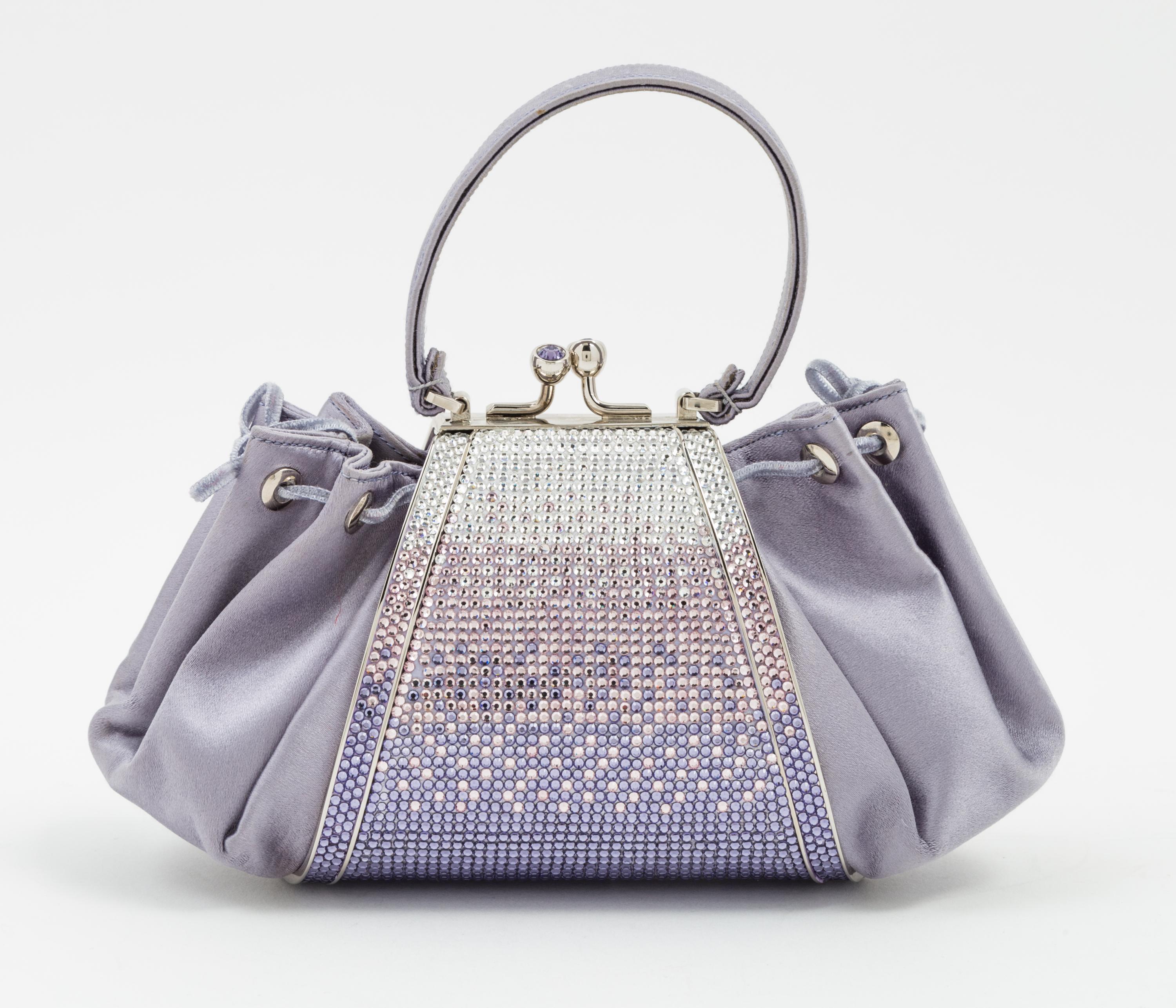 A Judith Leiber Purple Satin and Crystal Handbag, 8" x 4" x 3".