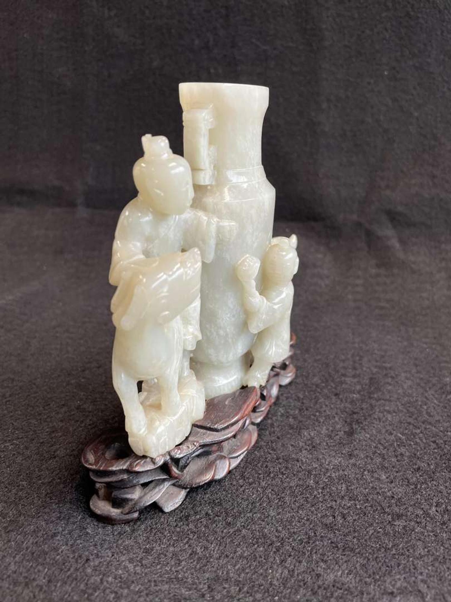 A Chinese jade "Boys, Kylin and Phoenix" vase on carved wood stand 玉雕童子凤鸟花樽及底座