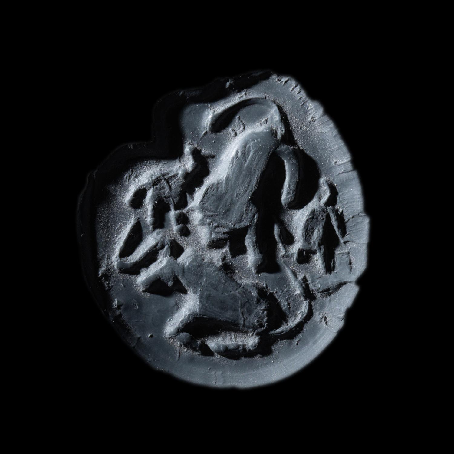 A Mesopotamian Green Stone Seal with a Lion Head