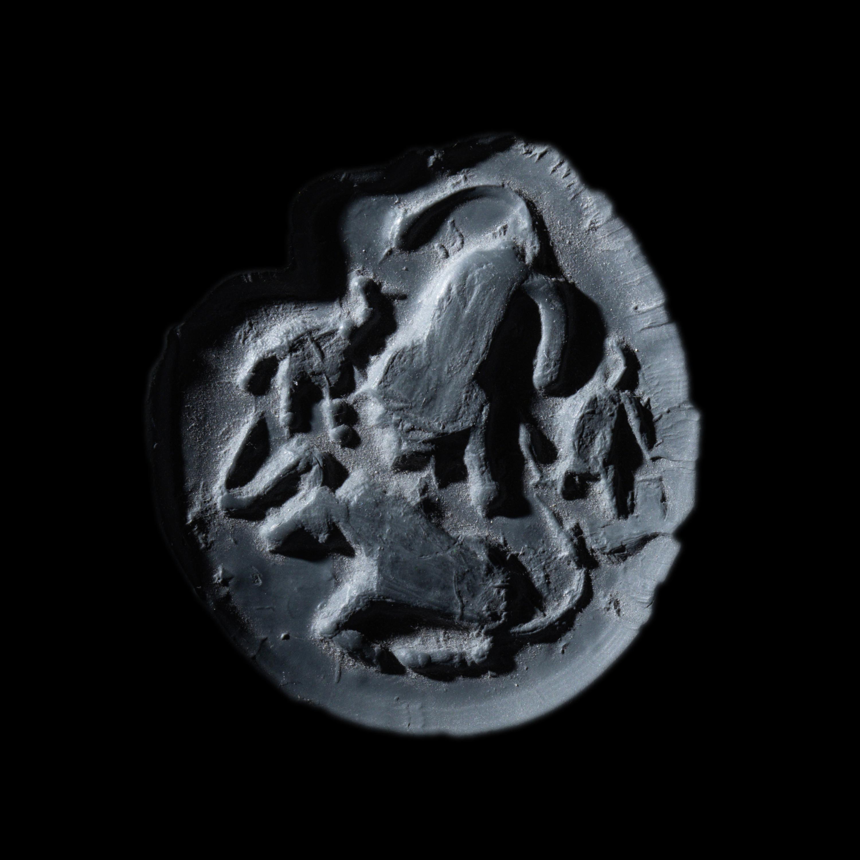 A Mesopotamian Green Stone Seal with a Lion Head