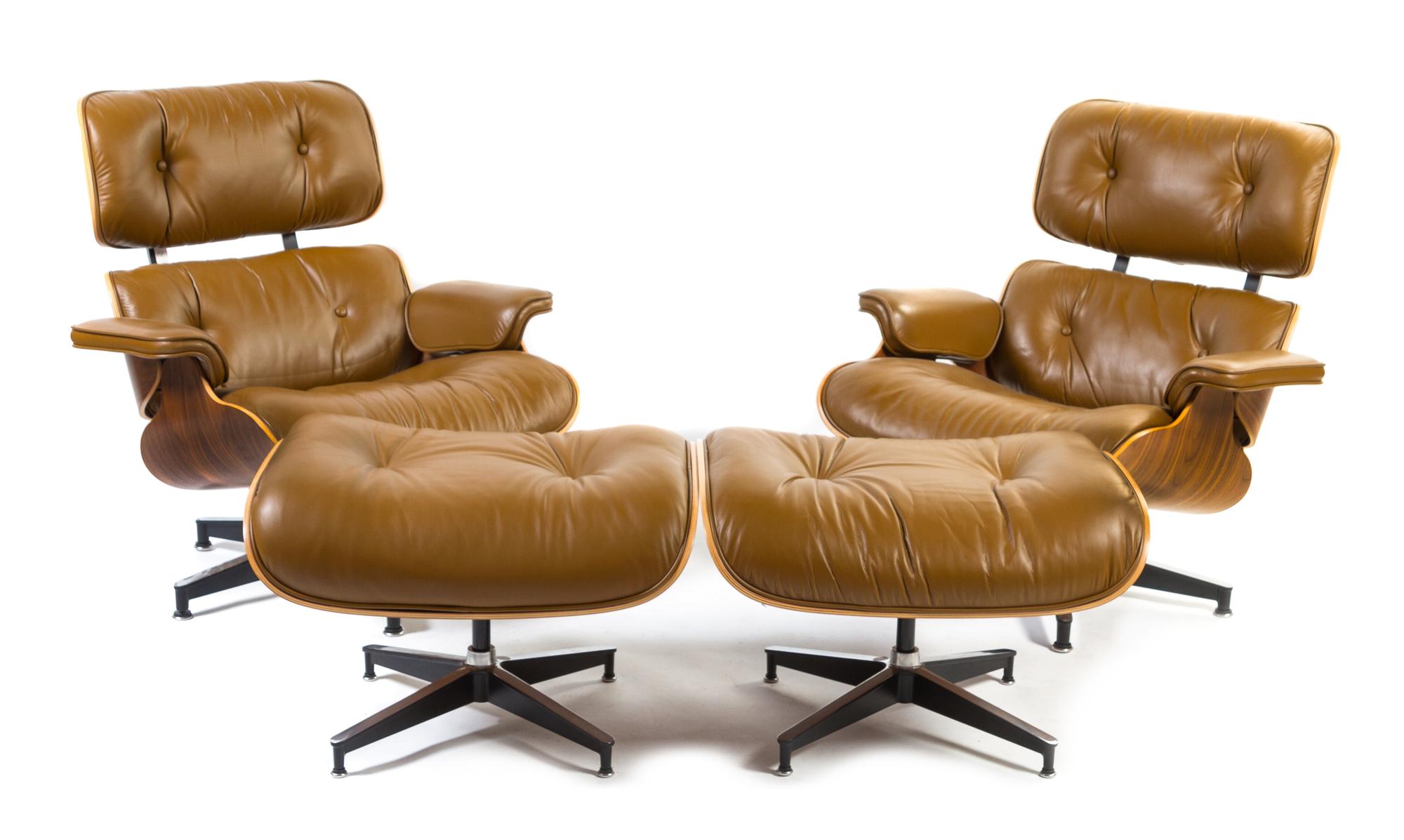 A Pair of Charles and Ray Eames for Herman Miller Leather Upholstered Lounge Chairs and Ottomans Height of chairs 33 inches.