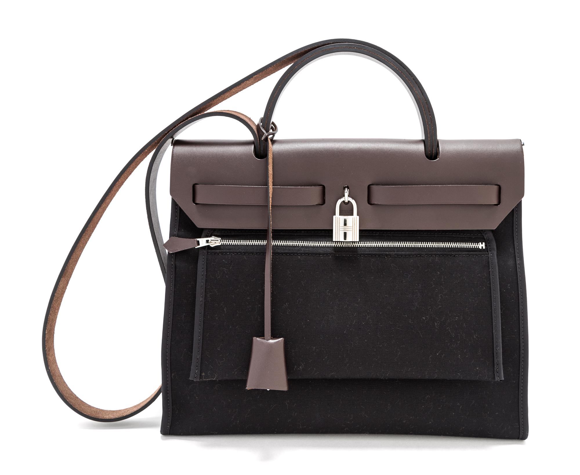 An Hermes Black Canvas and Chocolate Vache Herbag Zip PM 31, 12.25" x 10" x 4"; Strap drop: 19"; Handle drop: 4.5".