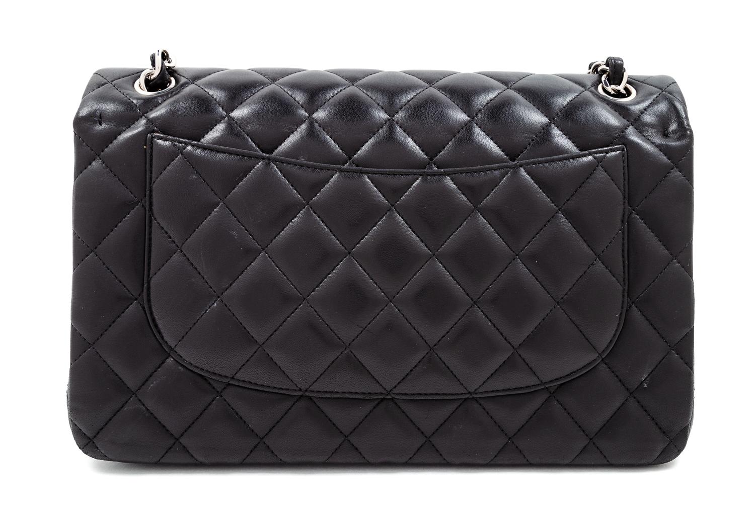A Chanel Black Quilted Lambskin Jumbo Double Flap Bag, 8.25" H x 12" W x 3.5" D; Strap drop: 13.5"- 23.75".