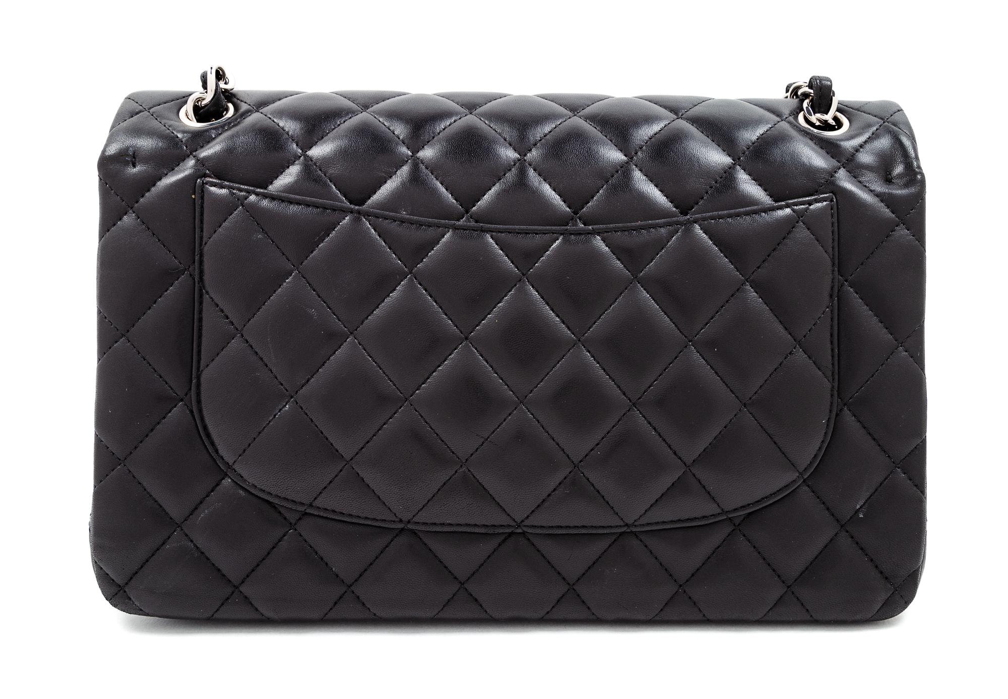 A Chanel Black Quilted Lambskin Jumbo Double Flap Bag, 8.25" H x 12" W x 3.5" D; Strap drop: 13.5"- 23.75".