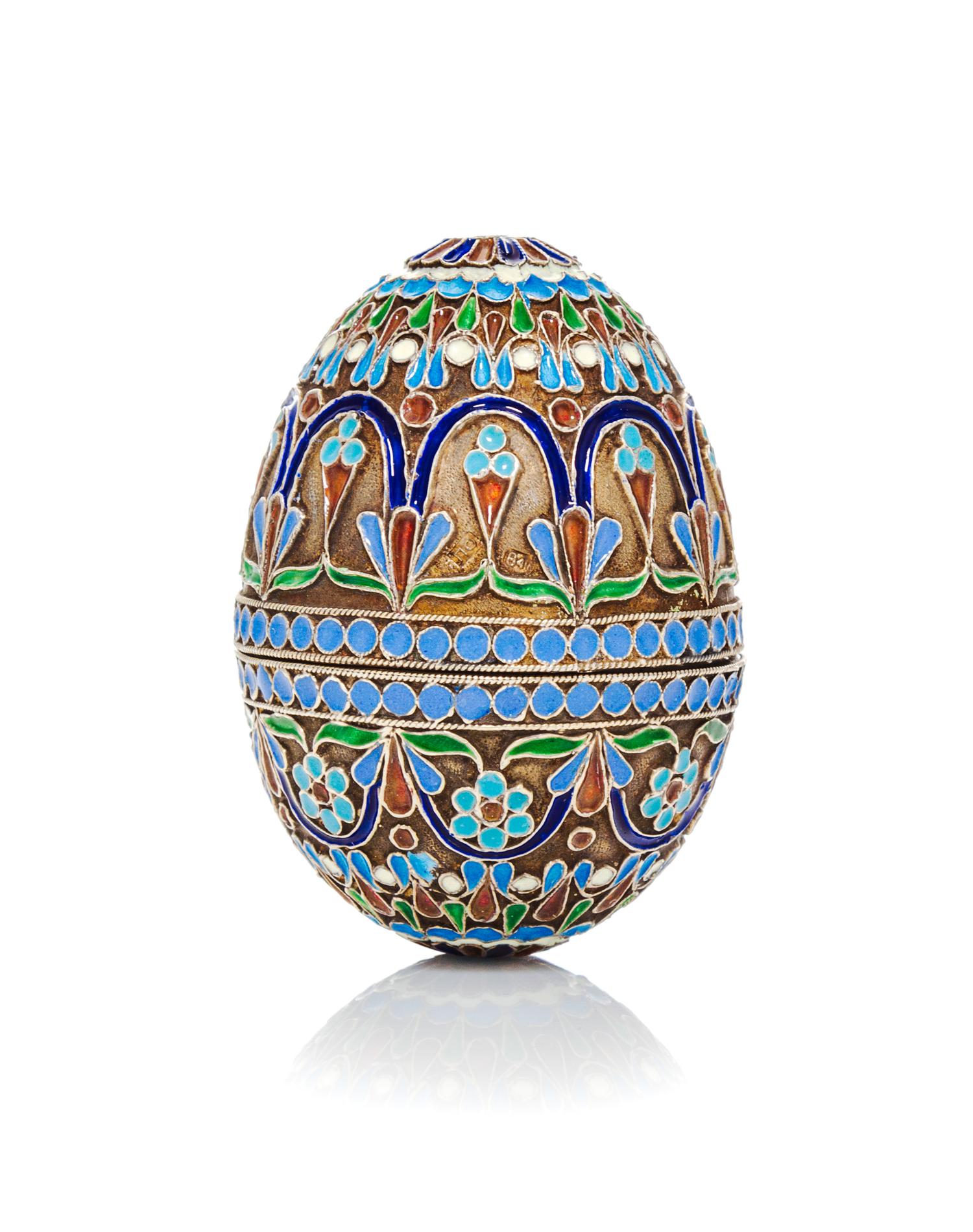 A Russian Enameled Silver-Gilt Egg, 19th Century, in two parts with allover floral decoration.