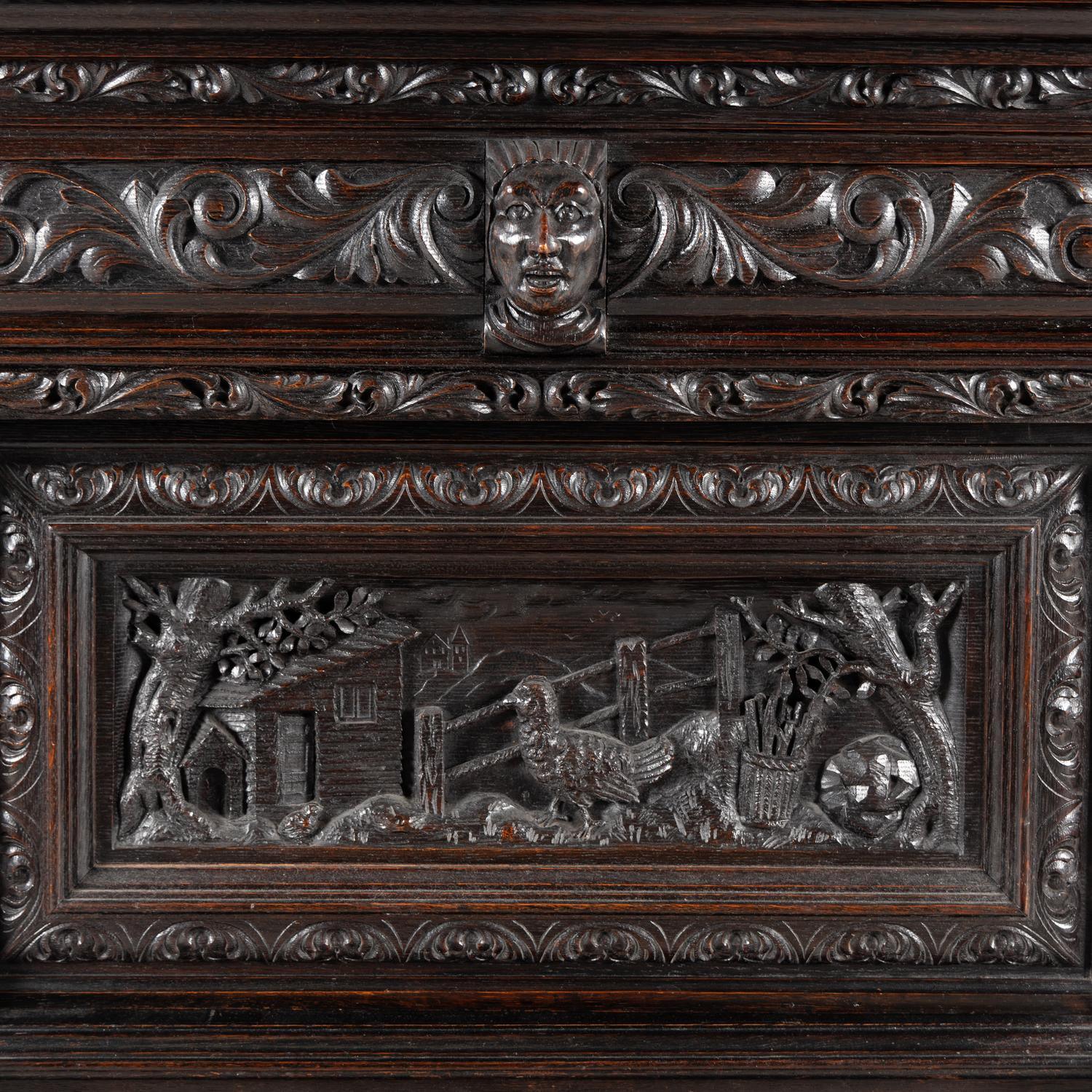 An Italian Renaissance Revival Carved Oak Bureau Cabinet on Stand