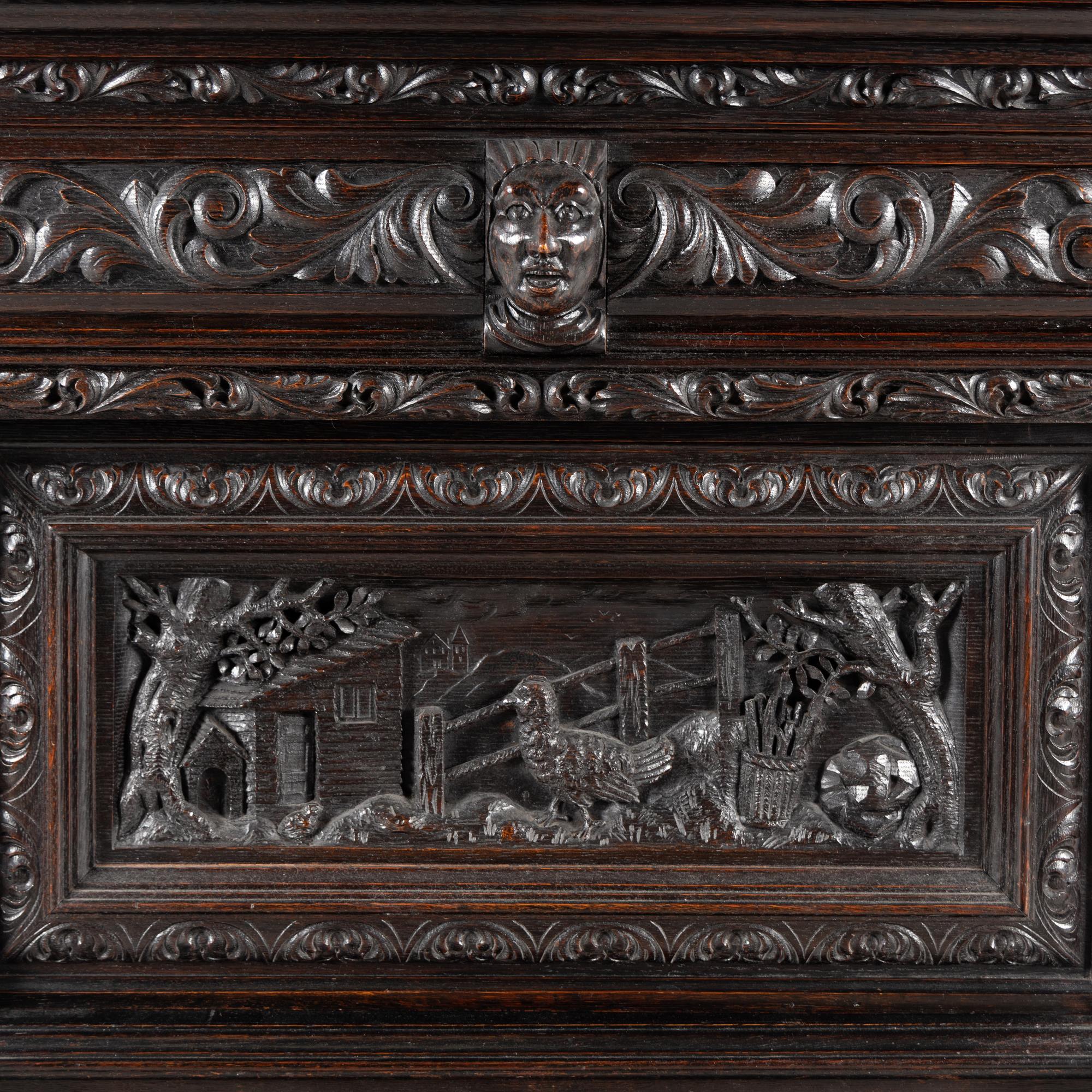 An Italian Renaissance Revival Carved Oak Bureau Cabinet on Stand