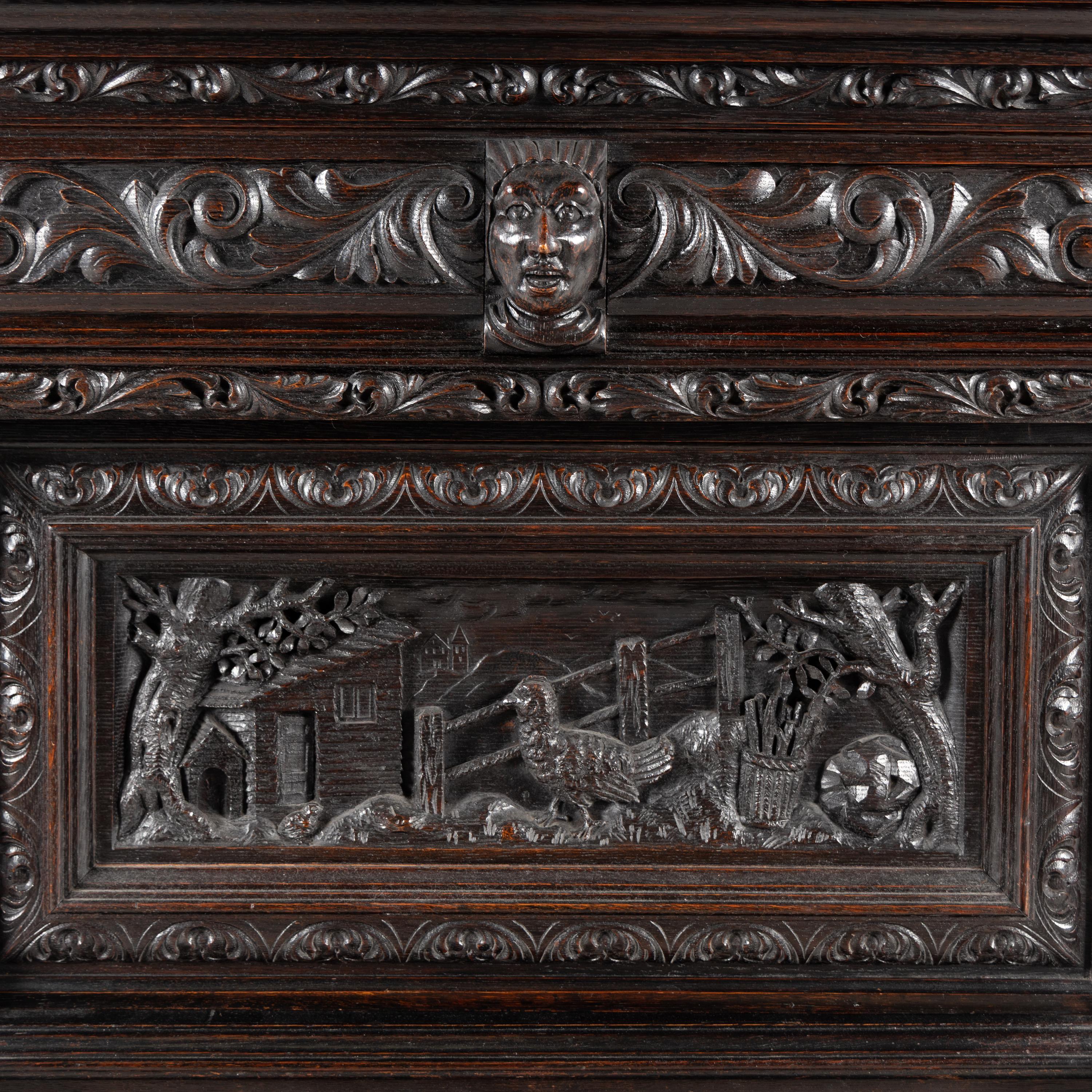 An Italian Renaissance Revival Carved Oak Bureau Cabinet on Stand