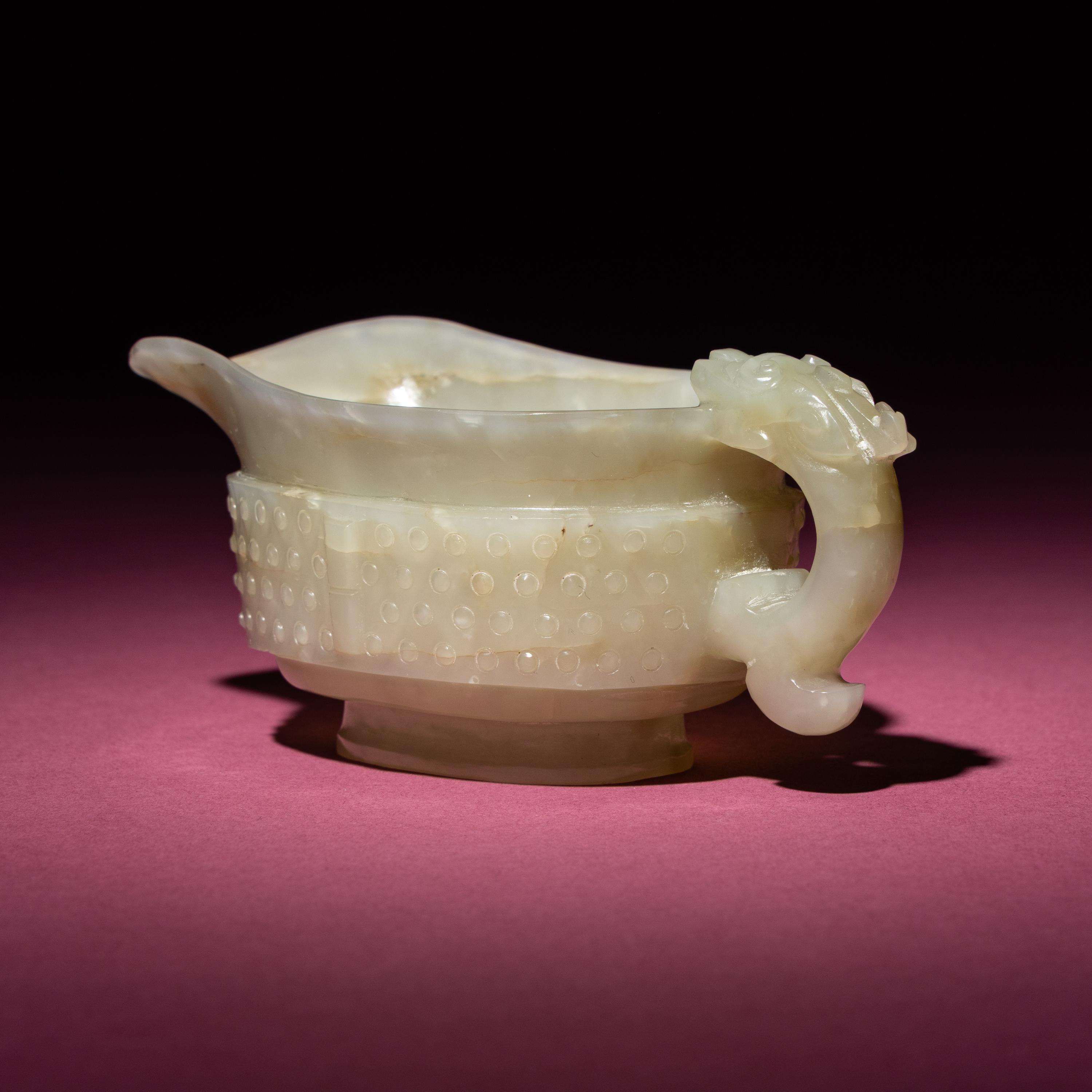 A Chinese Pale Celadon Jade Archaistic Yi Vessel, 17th Century — 清早期 青白玉仿古龍紋匜