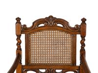 A William and Mary Style Carved Oak Cane Back Armchair