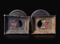 A pair of Chinese lion-form patinated bronze candle sticks, Qing dynasty, possibly Kangxi period 獅形銅加漆燭臺一對 清 可能為康熙