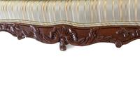 A Pair of Louis XV Style Carved Walnut Fauteuils