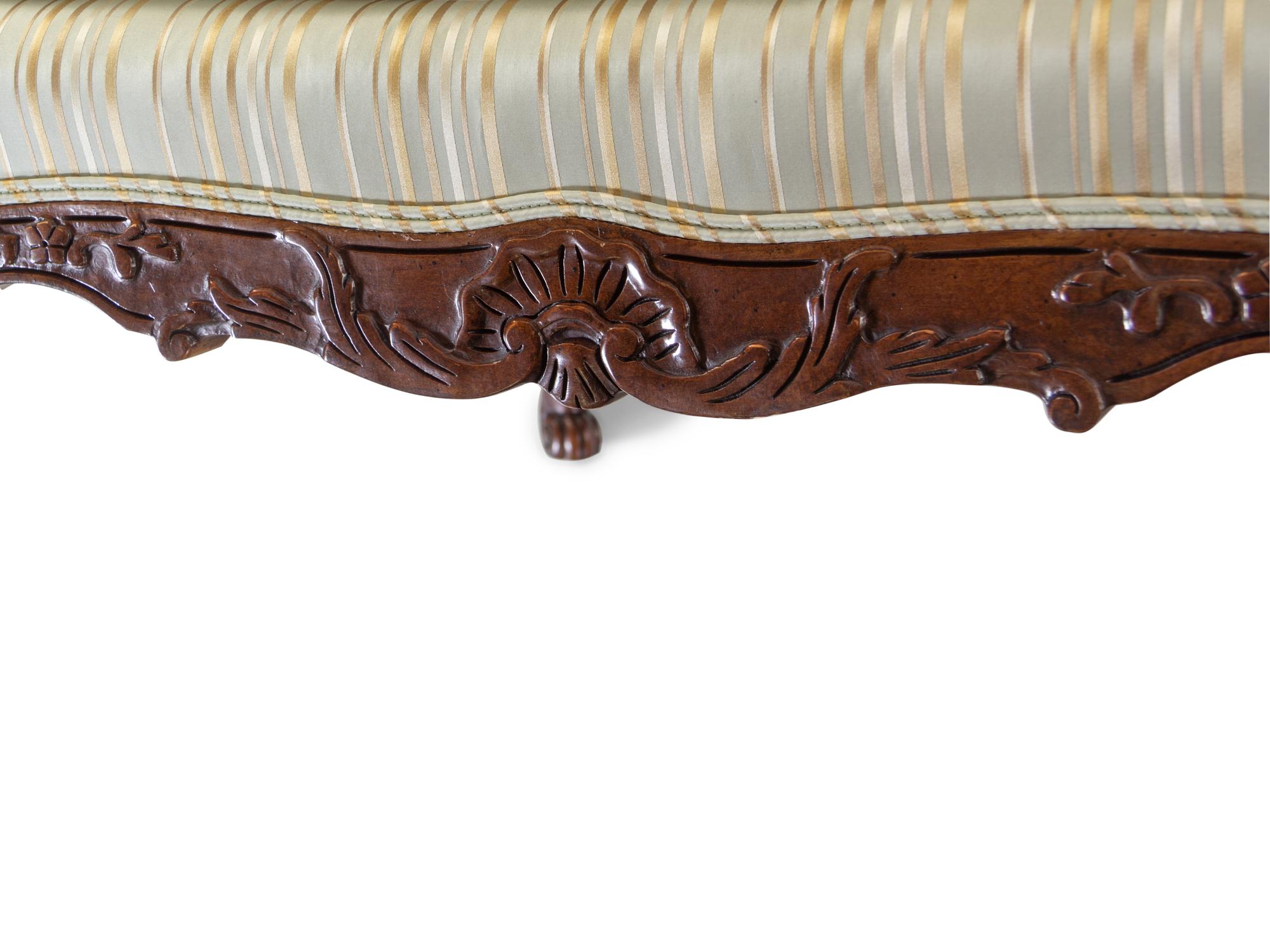 A Pair of Louis XV Style Carved Walnut Fauteuils