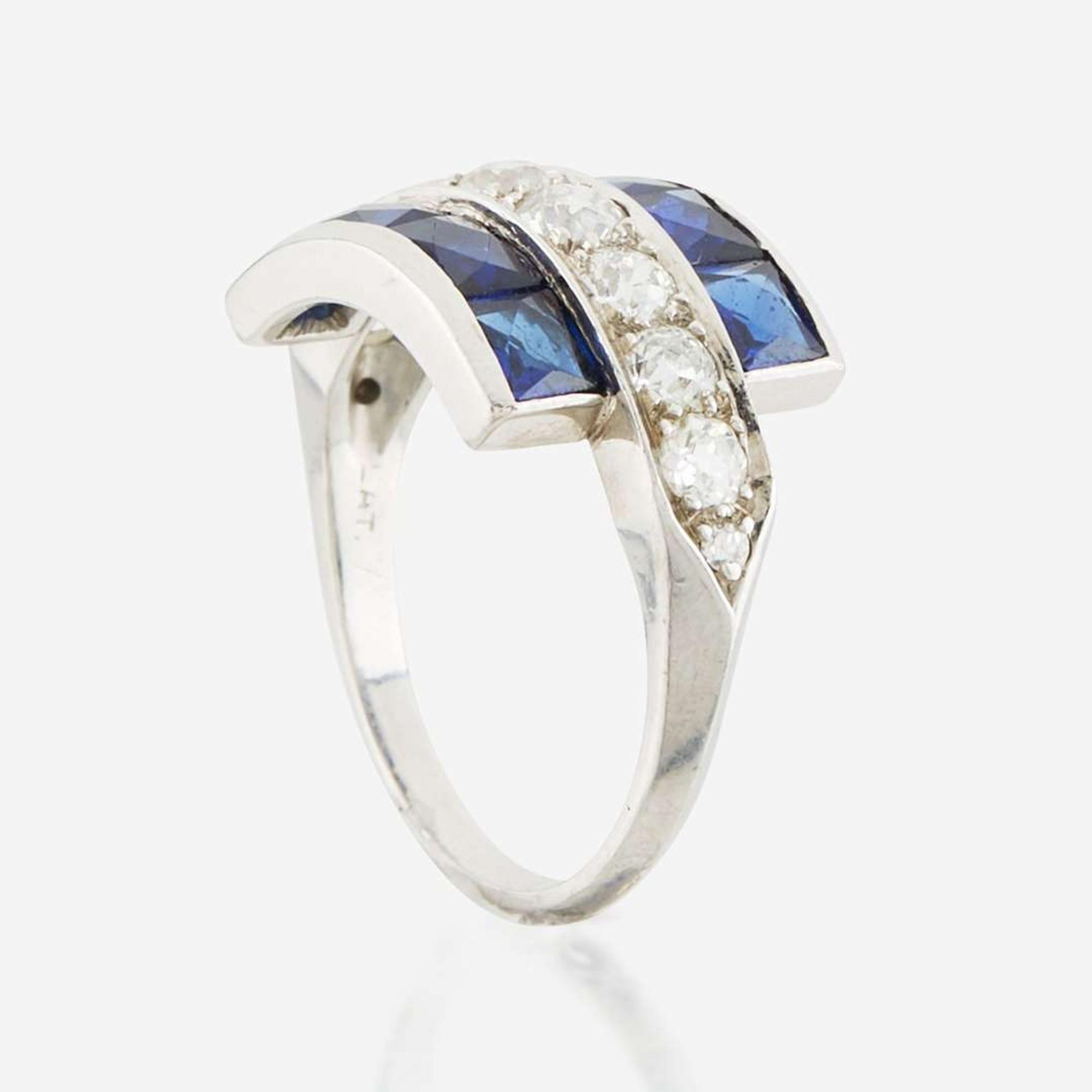 A diamond, blue glass, and platinum ring