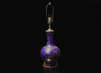 A Chinese gilt-decorated blue-glazed porcelain “Dragons” vase 藍地金彩雲龍紋賞瓶
