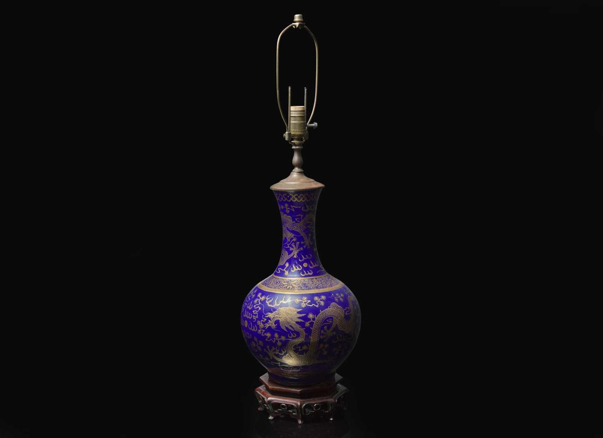 A Chinese gilt-decorated blue-glazed porcelain “Dragons” vase 藍地金彩雲龍紋賞瓶