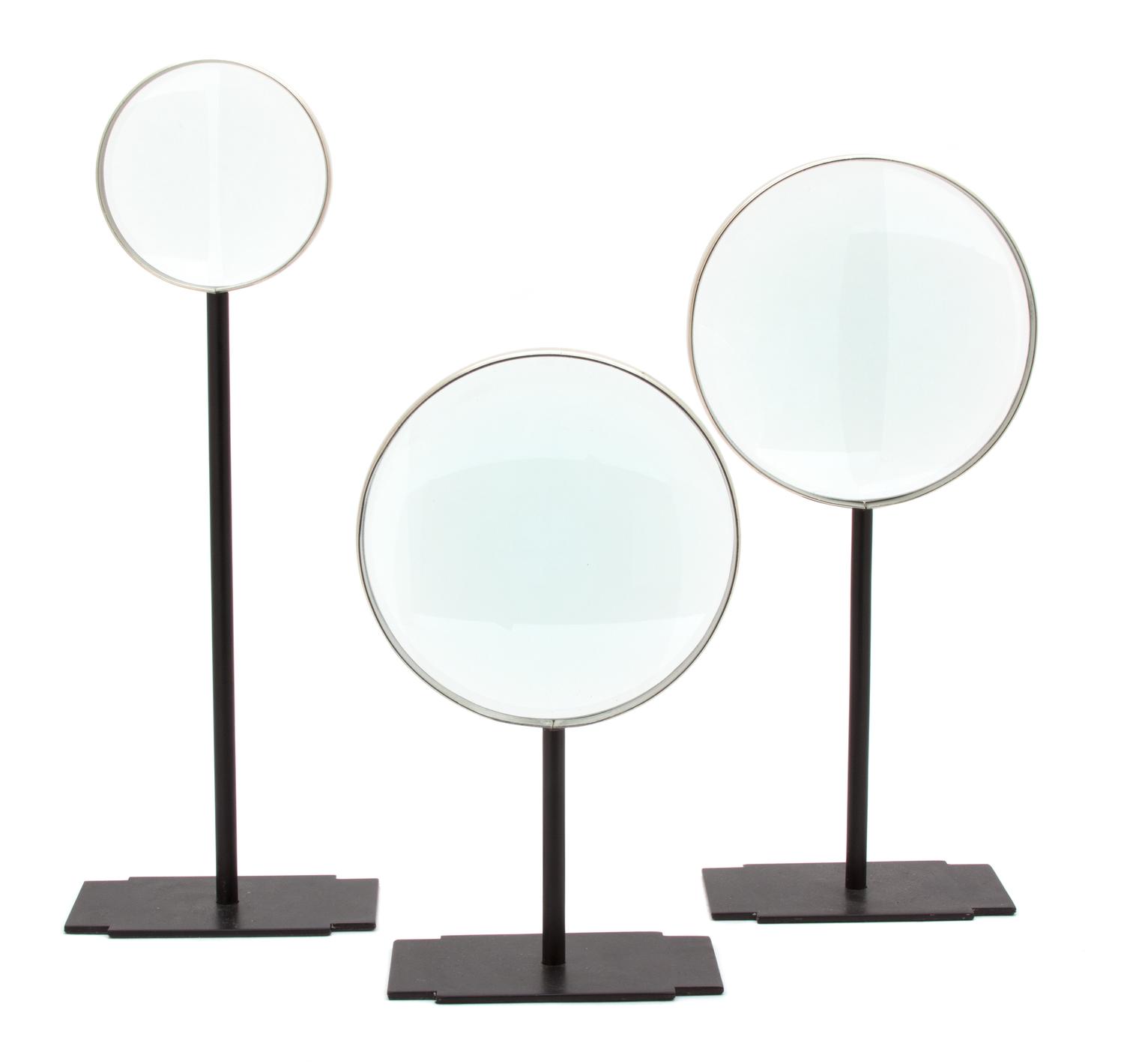 Three Metal Mounted Magnifying Glasses on Black Metal Stands Height of tallest 15 1/4 inches.