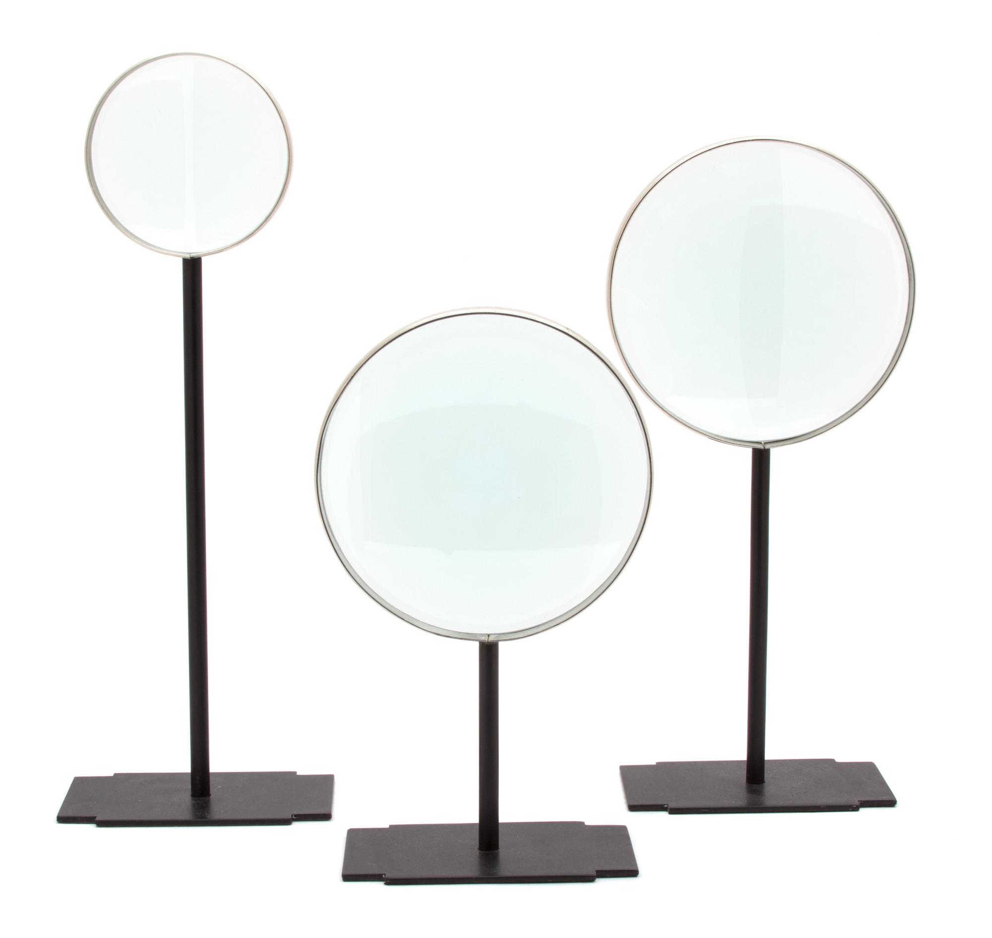 Three Metal Mounted Magnifying Glasses on Black Metal Stands Height of tallest 15 1/4 inches.
