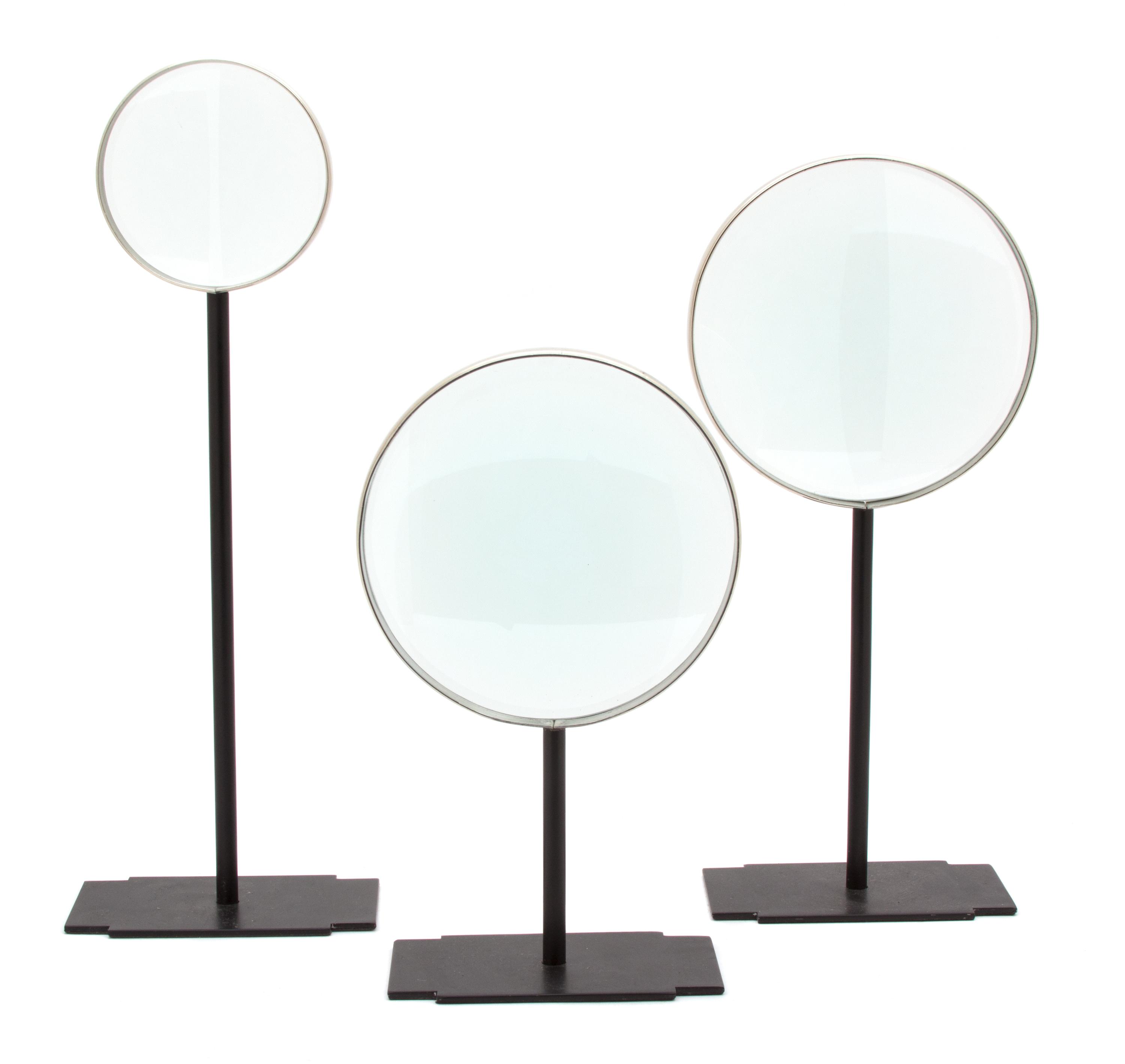 Three Metal Mounted Magnifying Glasses on Black Metal Stands Height of tallest 15 1/4 inches.