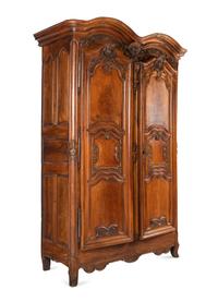 A Louis XV Carved Walnut Armoire