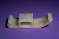 A Chinese White and Russet Jade Sword Slide, Jianzhi