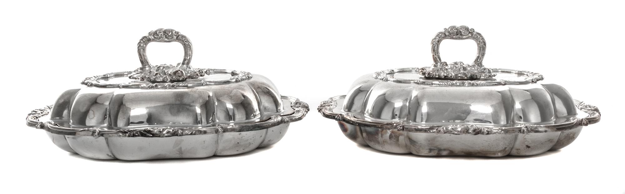 A Pair of Silver-Plate Covered Entree Dishes, 20th Century, each with foliate cast handle and border, unmarked.