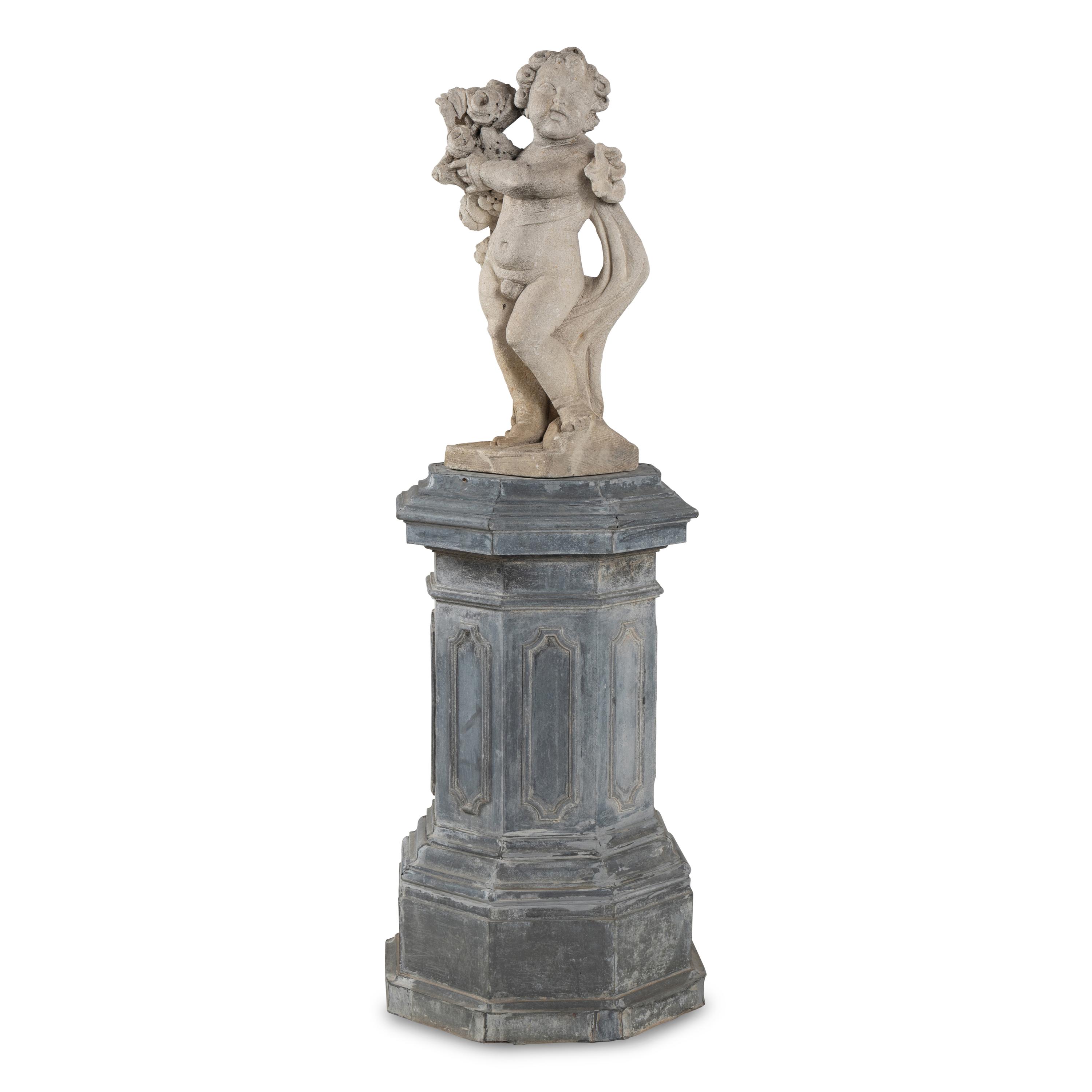 A Cast Stone Garden Figure of a Putto on a Zinc Pedestal