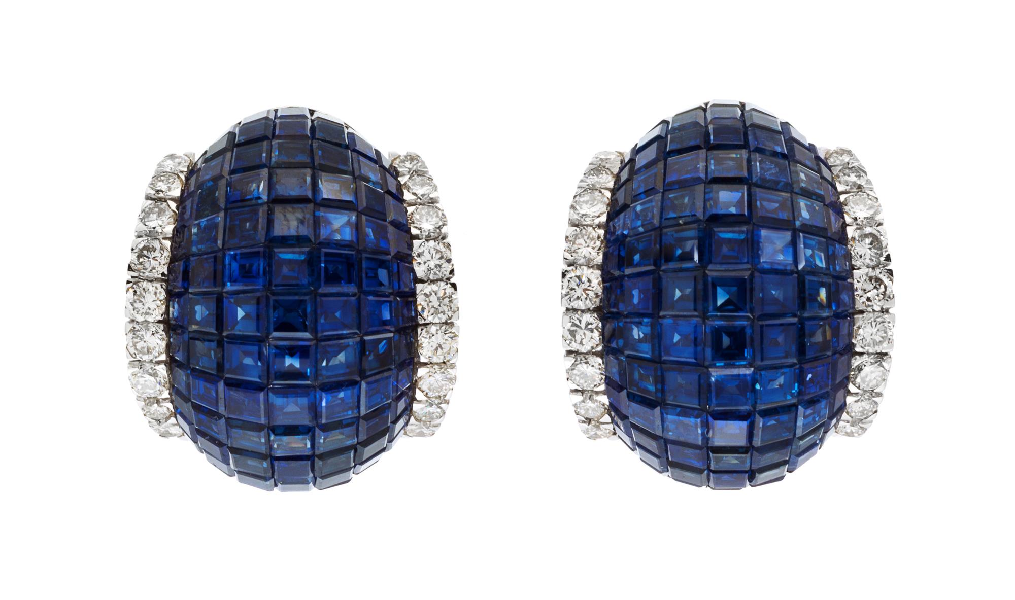 A Pair of 18 Karat White Gold and Invisibly Set Sapphire and Diamond Earclips, 14.90 dwts.