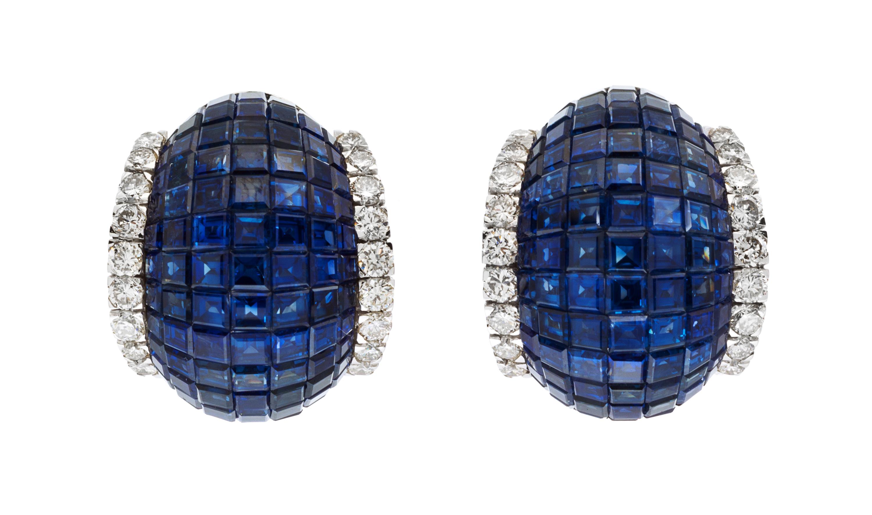A Pair of 18 Karat White Gold and Invisibly Set Sapphire and Diamond Earclips, 14.90 dwts.