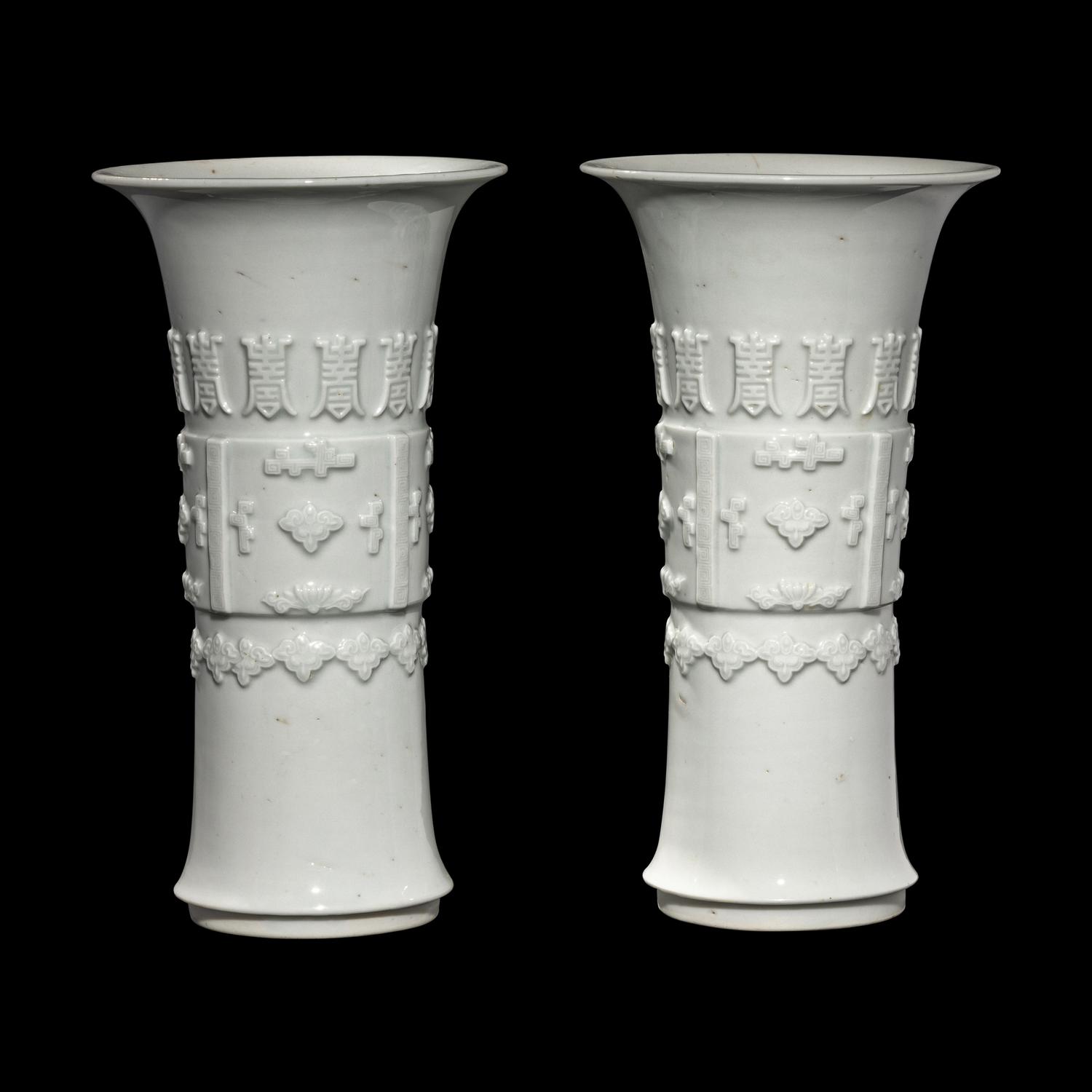 A Pair of Chinese Blanc-de-Chine Porcelain Gu Vases, Qing Dynasty 清 德化白瓷貼塑萬壽 如意花觚 一對
