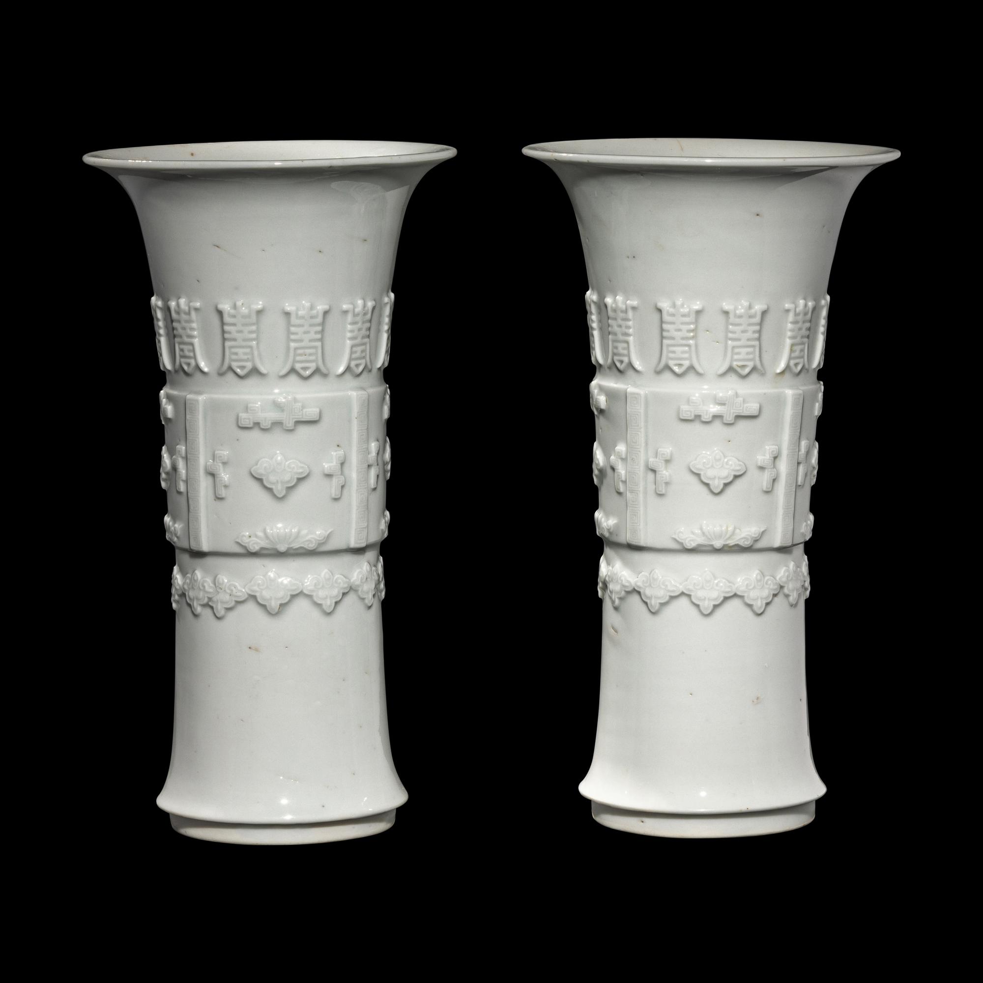 A Pair of Chinese Blanc-de-Chine Porcelain Gu Vases, Qing Dynasty 清 德化白瓷貼塑萬壽 如意花觚 一對